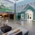 Grand Paradise Playa Dorada lobby in Puerto Plata with colorful mural, seating area and open reception