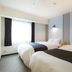 Court Hotel Shinyokohama in Yokohama: twin beds in a bright hotel room with window light