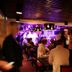 Hotelli Emilia in Hämeenlinna with a lively bar full of guests under purple lighting