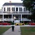 Bloomsbury Inn in Camden with a white two-story porch house and classic cars parked out front