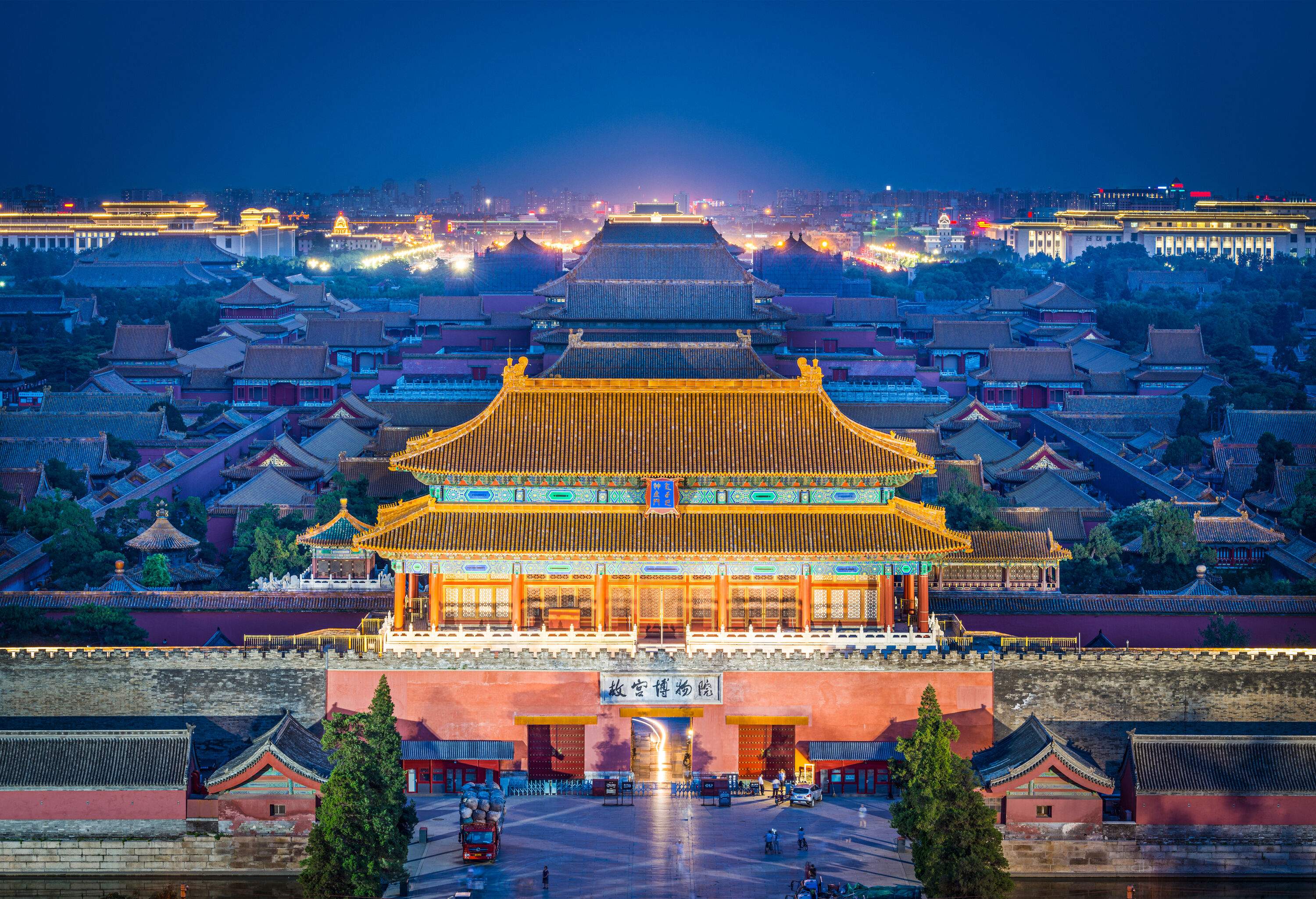 Brightly lit Imperial City North Gate, a part of the walled city, with picturesque brick-roofed houses.