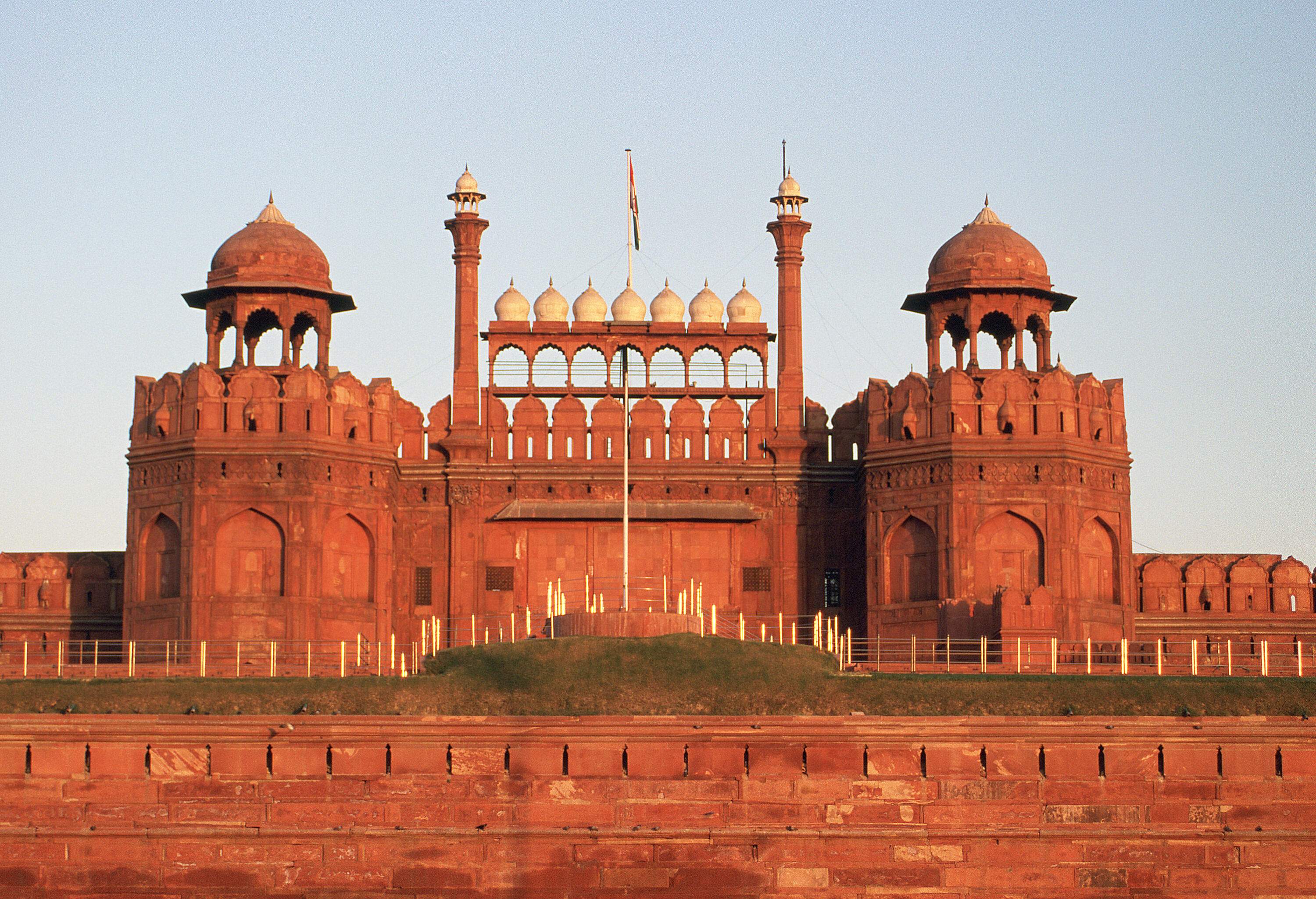A gateway with seven white marble domes between octagonal towers.