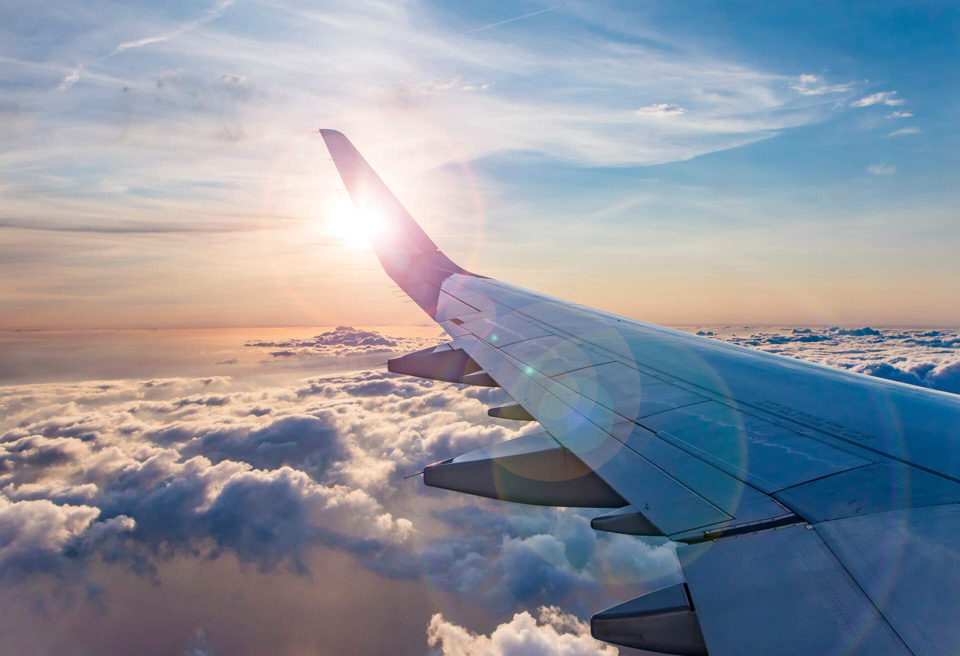 flying and traveling, view from airplane window on the wing on sunset time; Shutterstock ID 1128633611