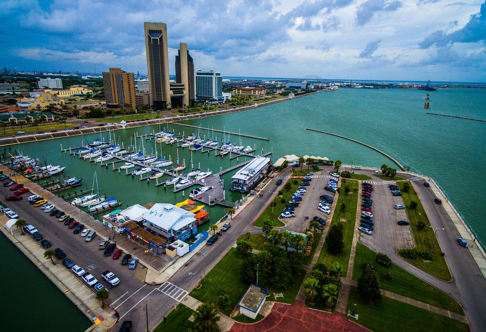 Paradise Gulf of Mexico Corpus Christi Texas Marina Aerial. The T-head with the marina , boats , sailboats , yachts , Tall Twin Towers at downtown Corpus Christi. Calm waters on the pier and inside the marina or harbor. The USS lexington is in the distance also called the 