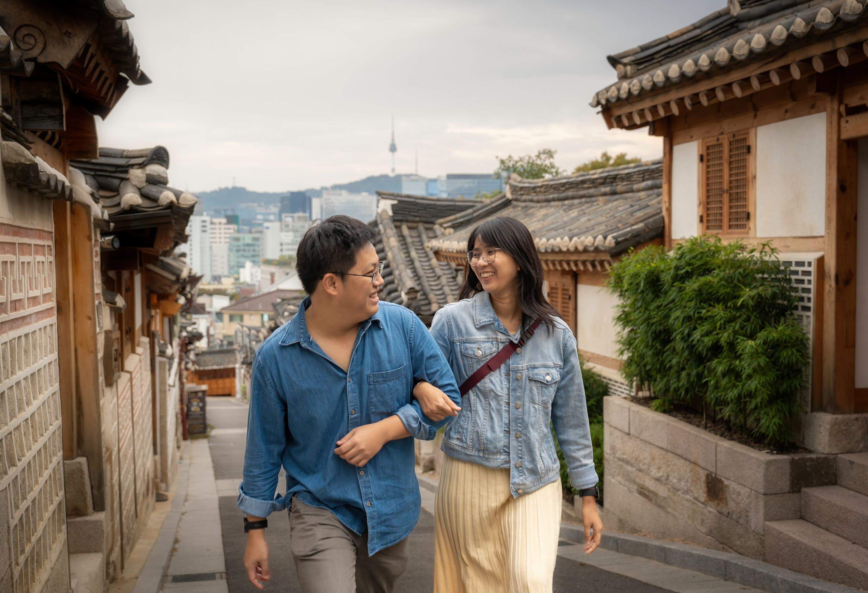Couple lover tourist travel at Bukchon Hanok village to relaxation hold hands and walk together in romantic scene Seoul. South korea. Physical Affection Southeast Asia concept.