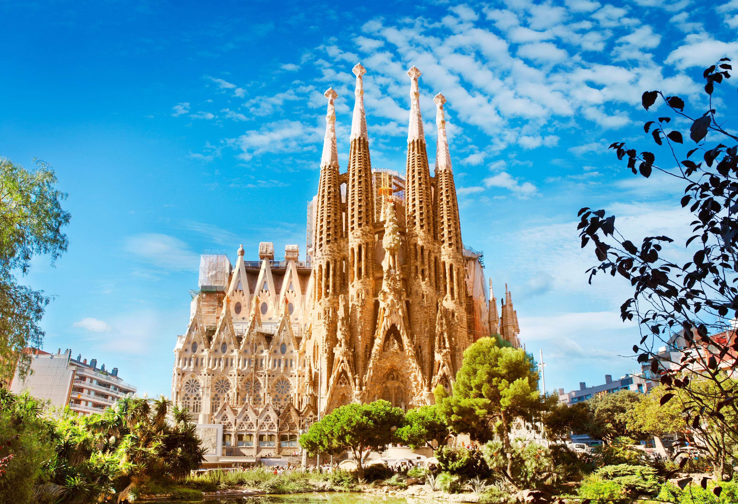 The majestic palatial façade of the Sagrada Familia cathedral in Barcelona, ​​Spain features Gothic and curvaceous Art Nouveau architecture.