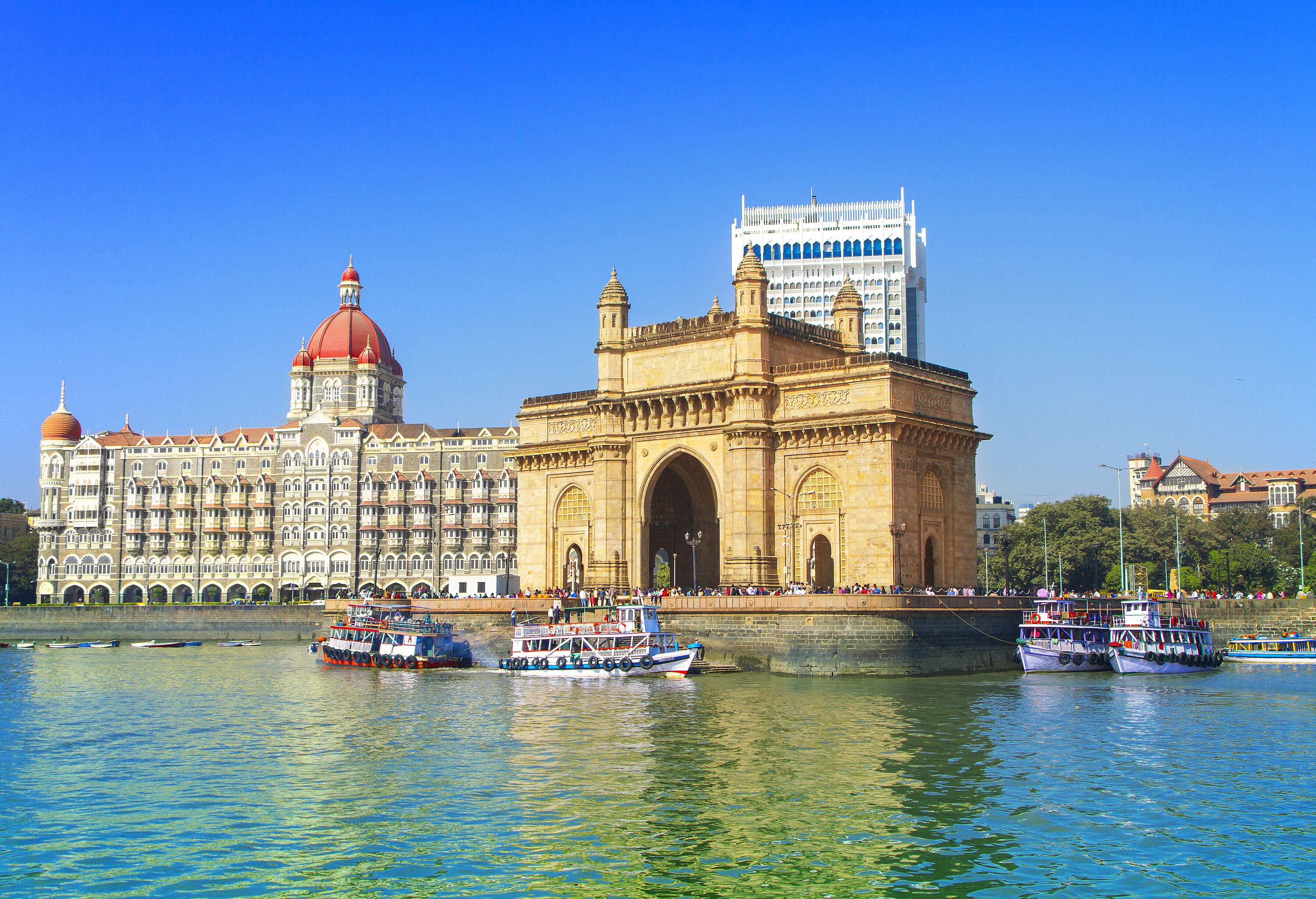 An enormous arch-monument gateway along the harbour stands beside the iconic Taj Mahal Palace.