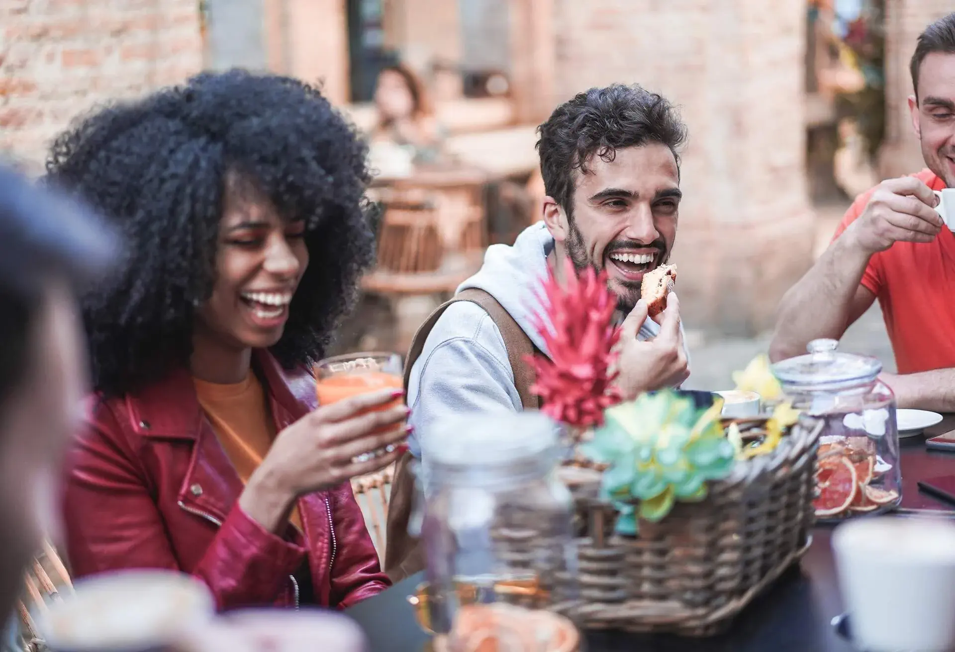A group of happy friends gathered together, sipping coffee while sharing laughter.