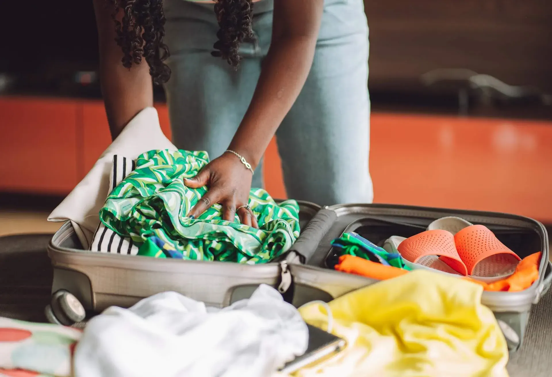 A woman packing her clothes in her suitcase
