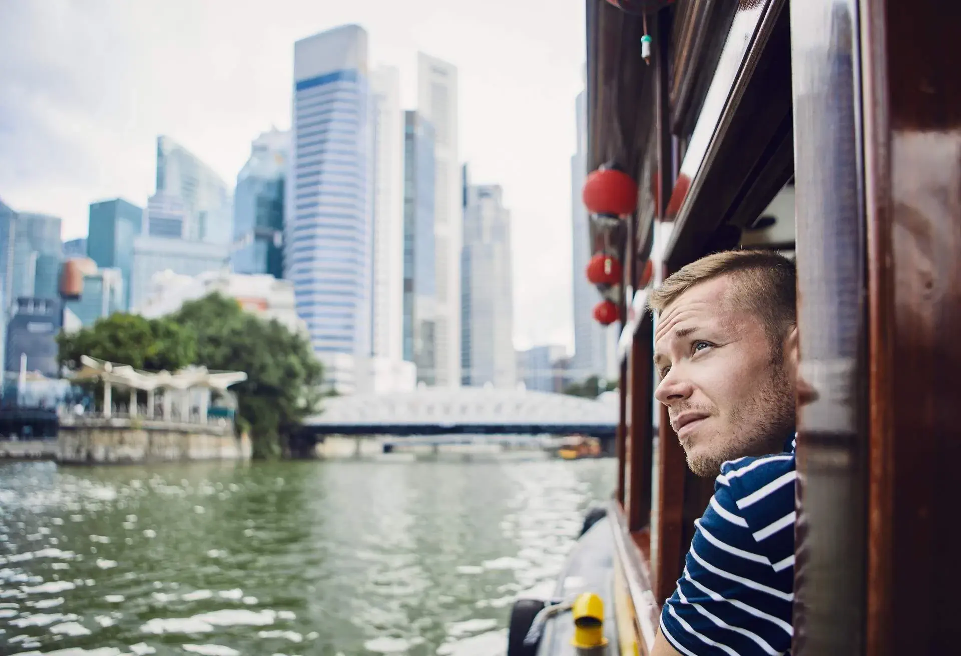 Man looking out ferry window in Singapore
