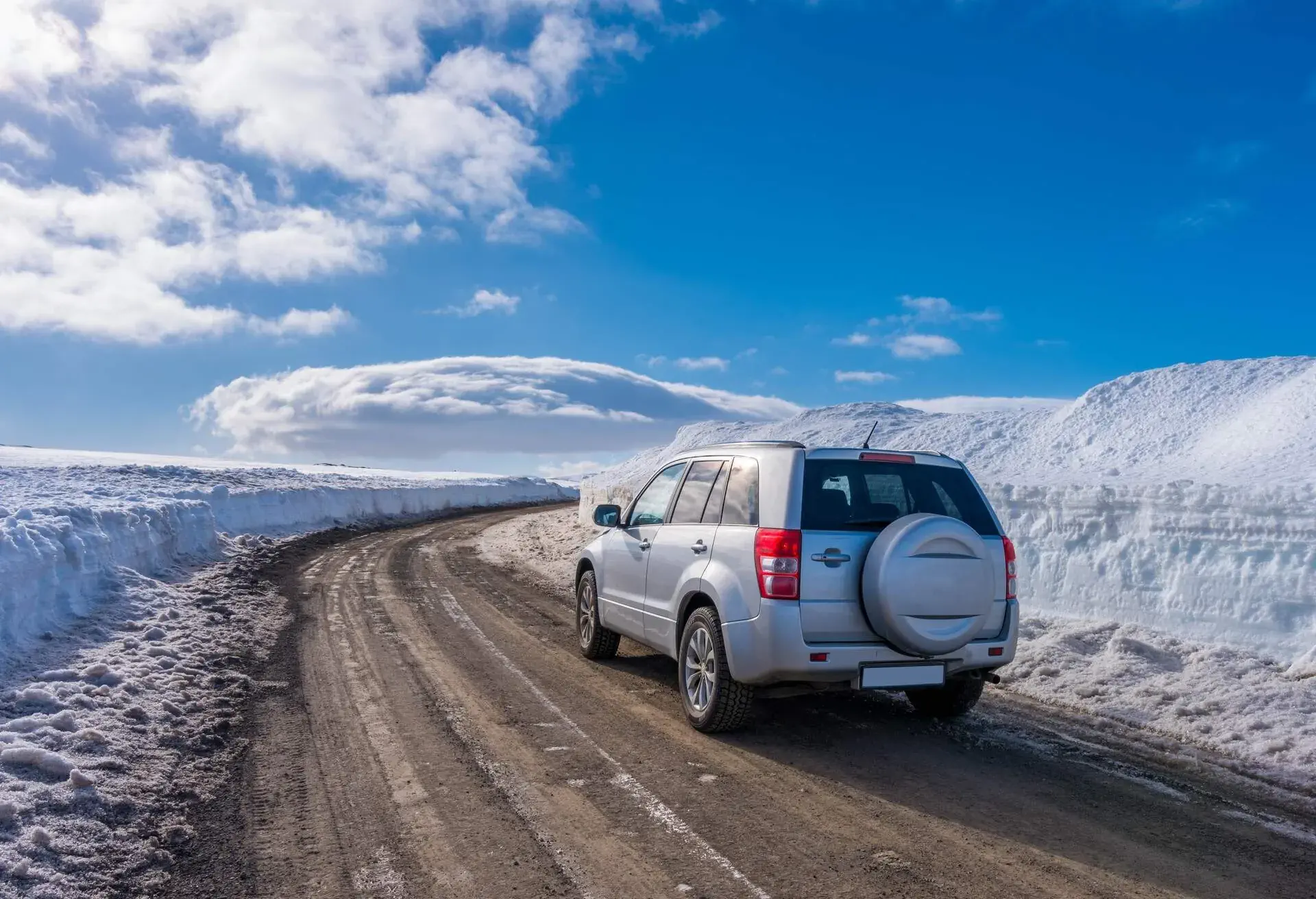 A AWD car rental on a snowy mountain road