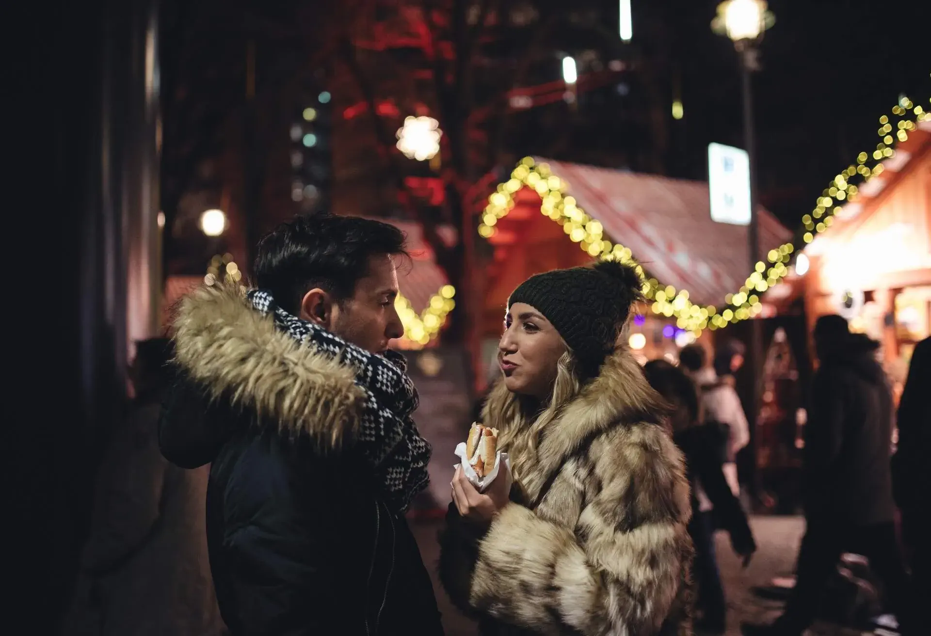Cheerful couple in love enjoying Berlin at Christmas season at a market
