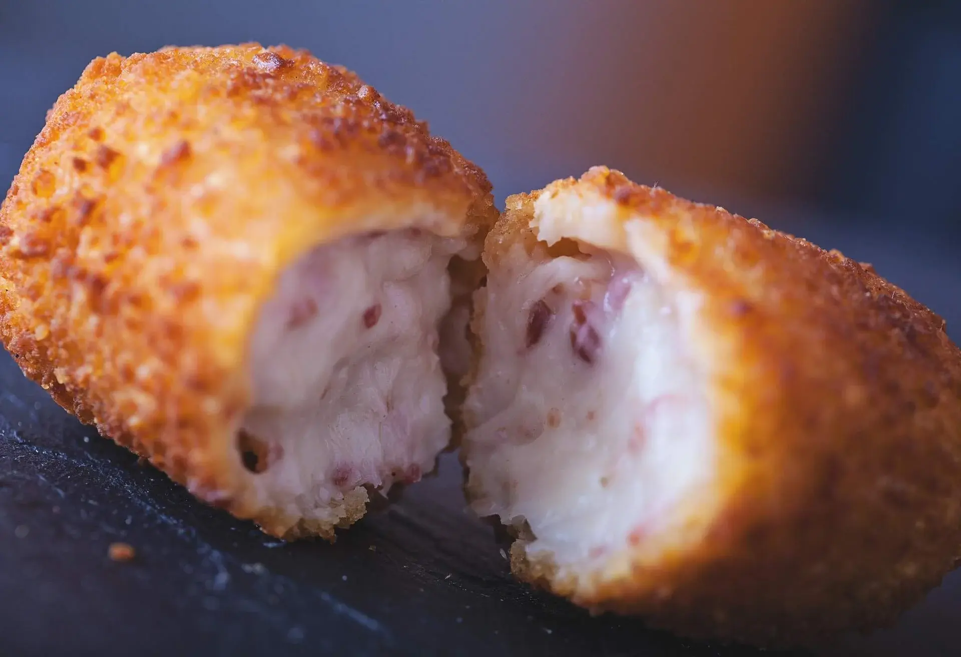 Croquetas cut open with ham and cheese filling