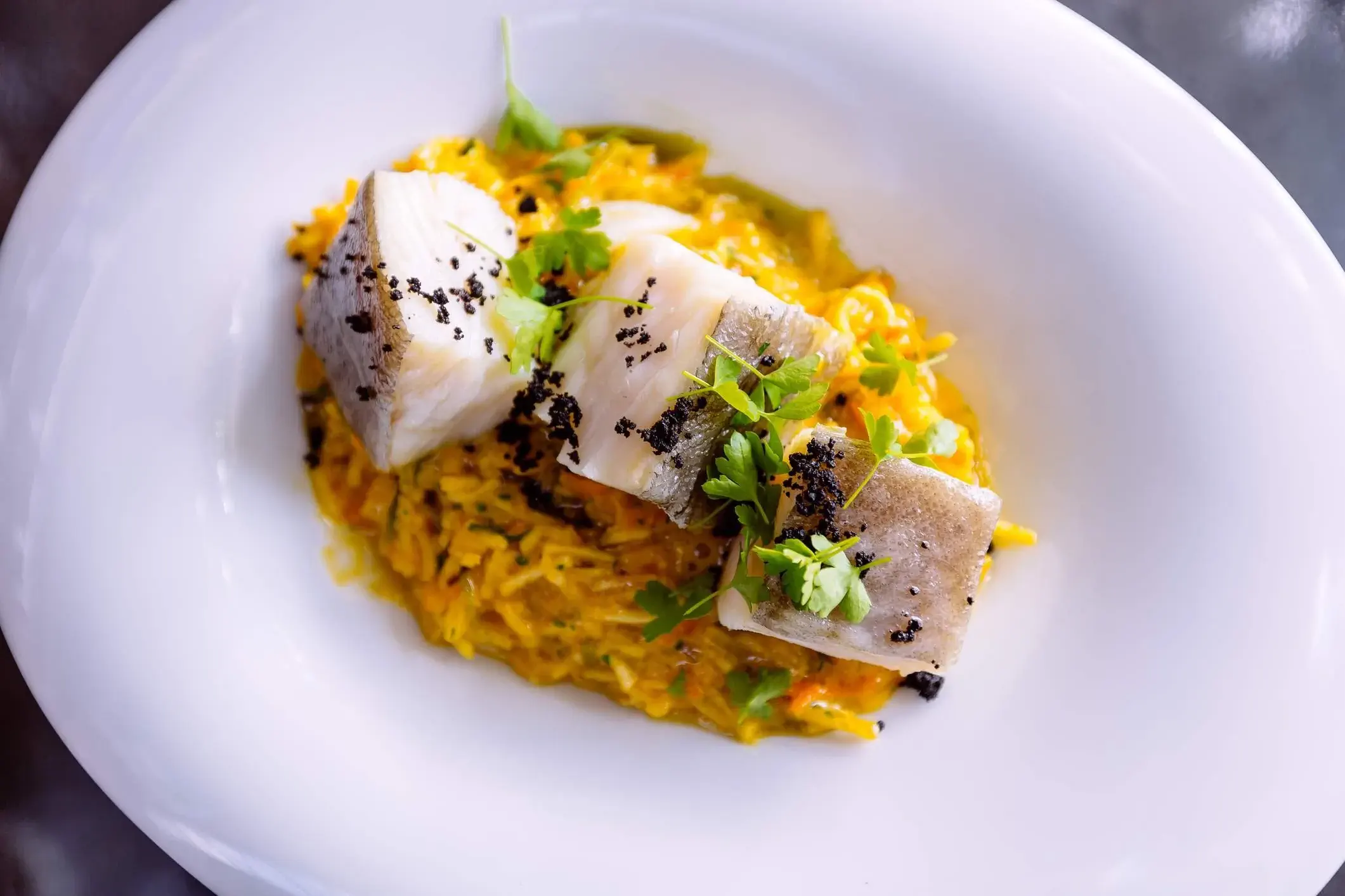 Bacalao on rice in a white plate