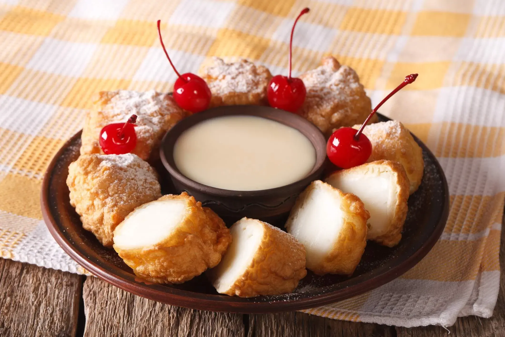 Leche frita on a black plate with yellow and white tablecloth