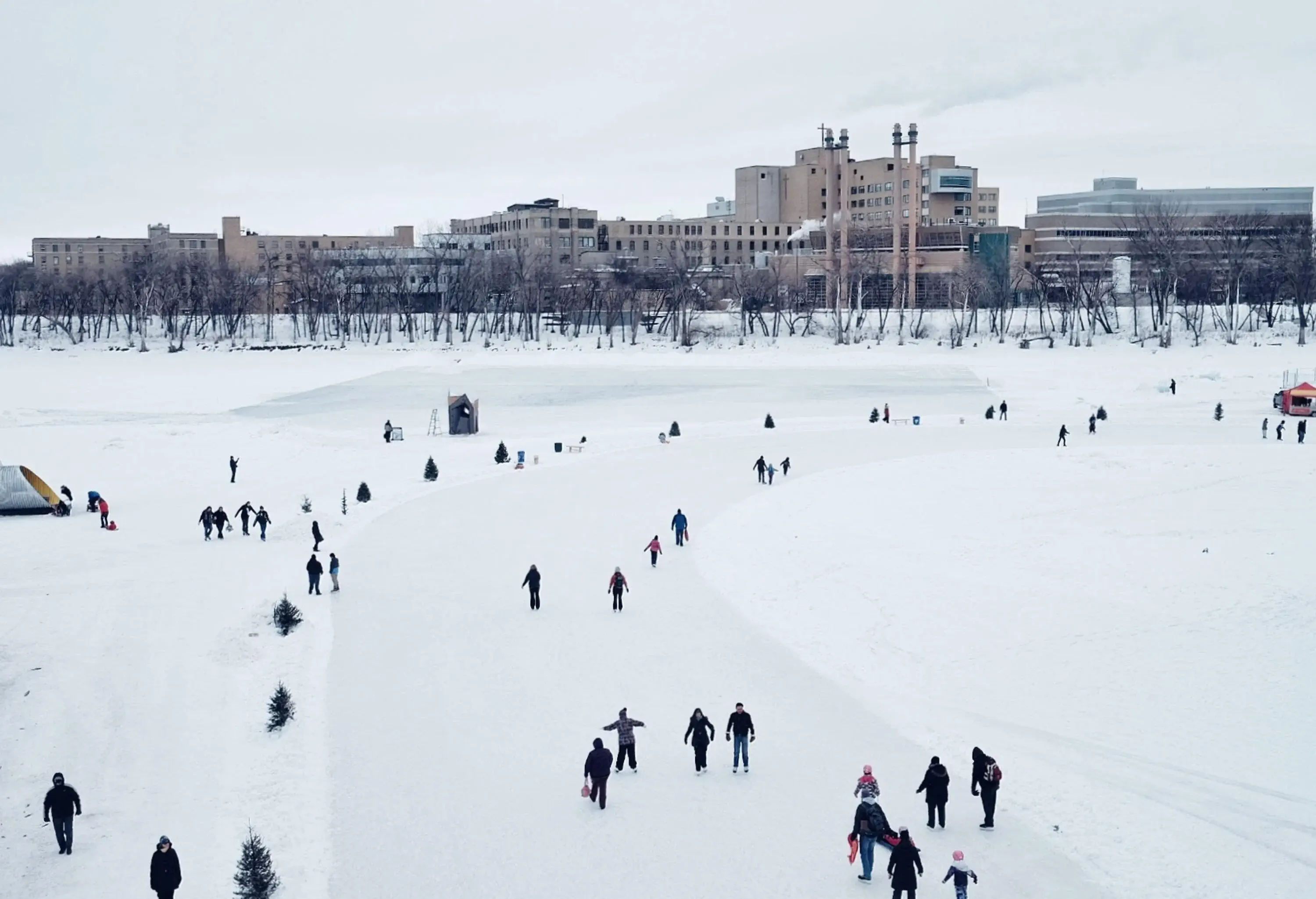 A group of people ice skating on a frozen river.