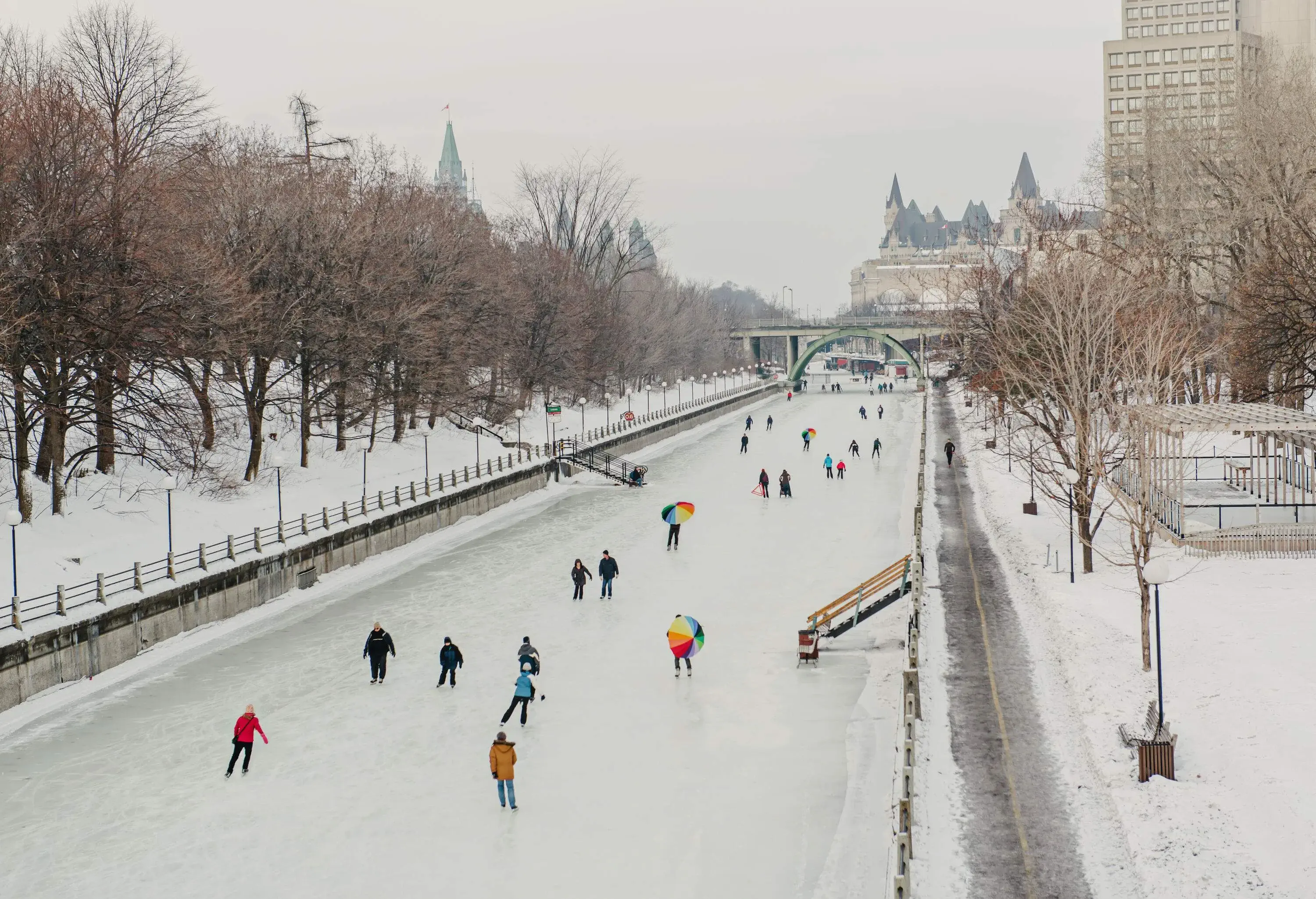 In winter, the canal turns into a skating rink line with trees where people enjoy gliding in the snow.