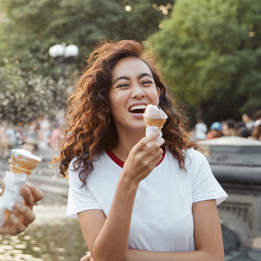 woman enjoying ice cream cone on a sunny day