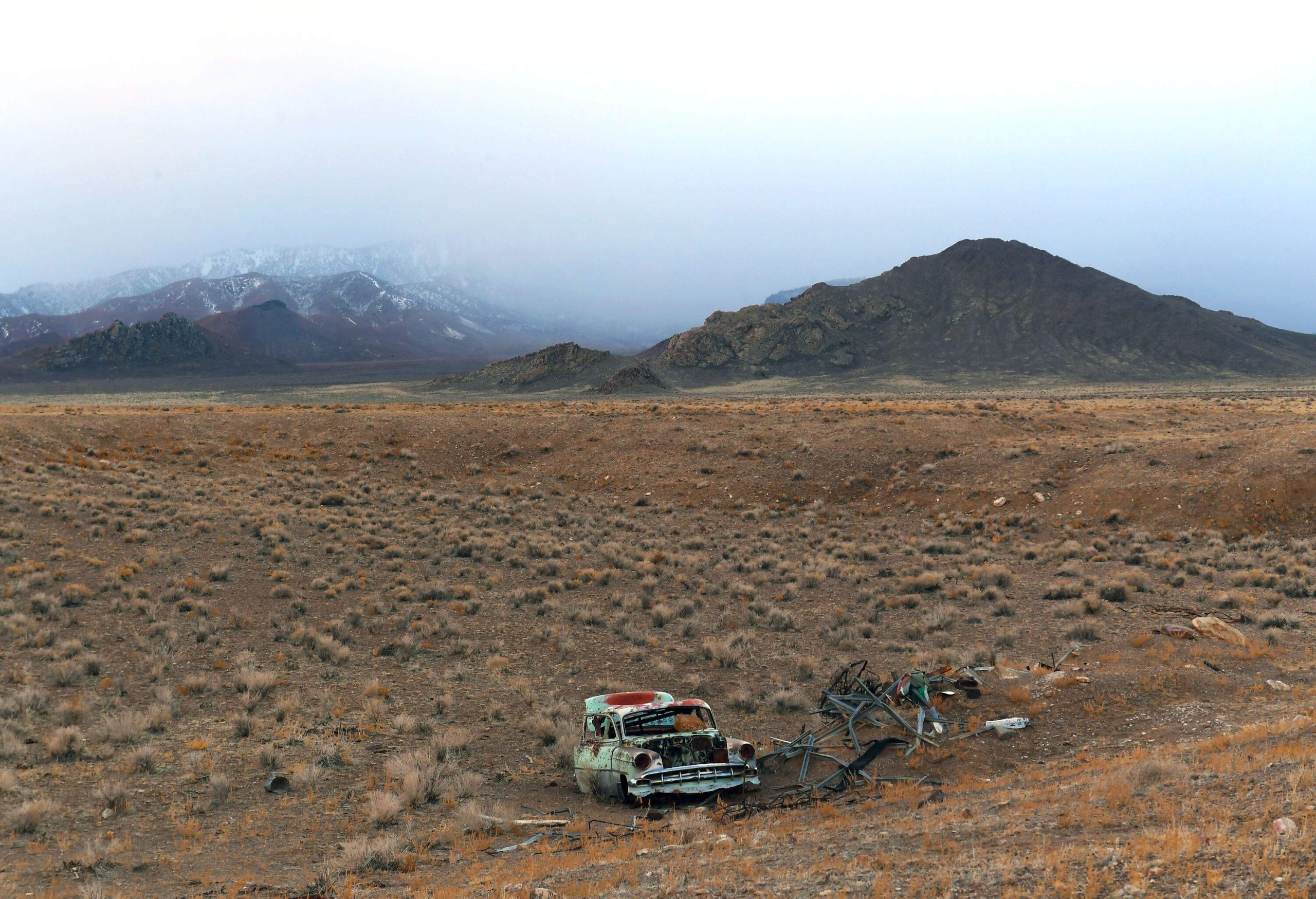 View of misty mountains over desolate road