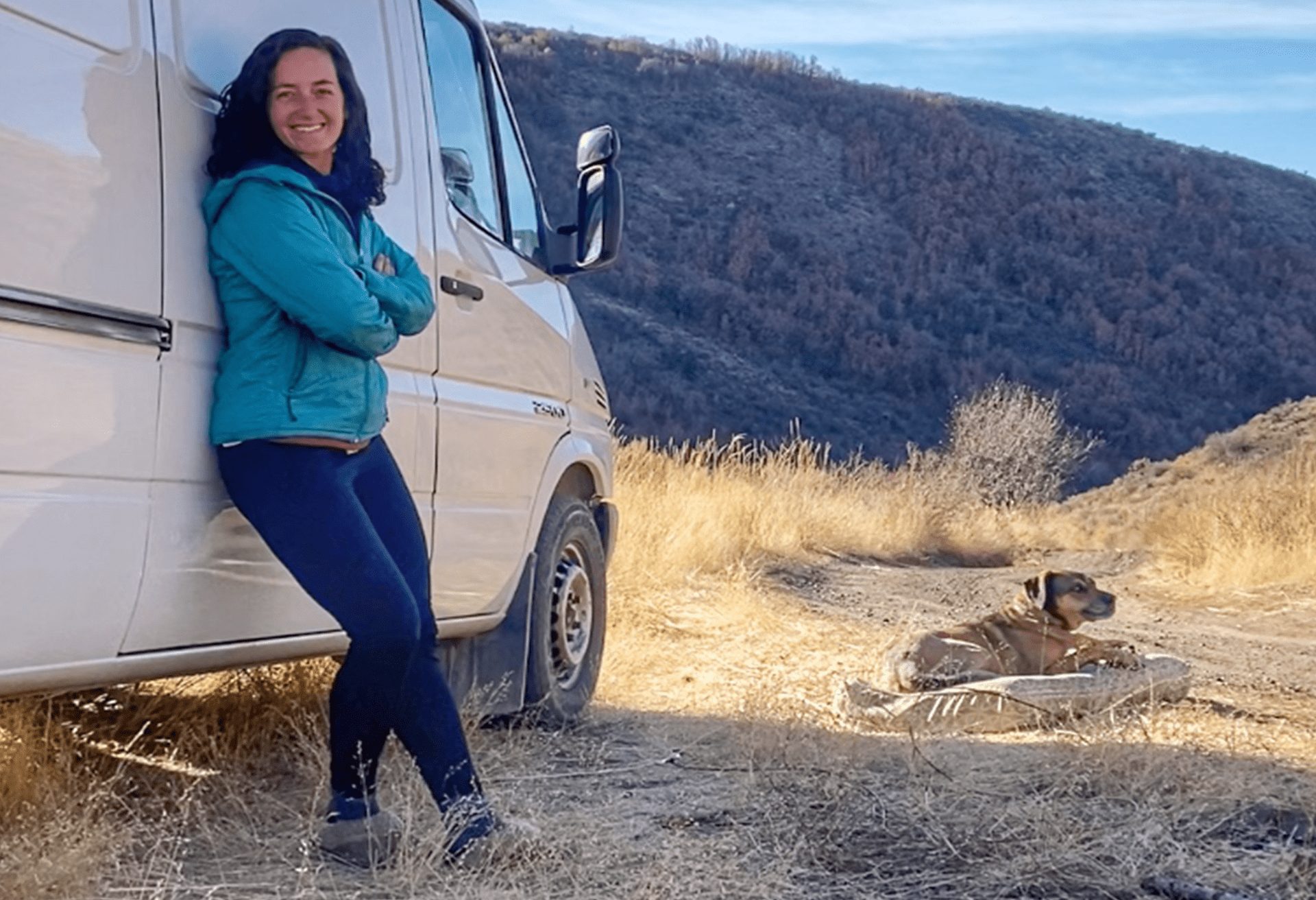 Jenny leans against the side of her van.