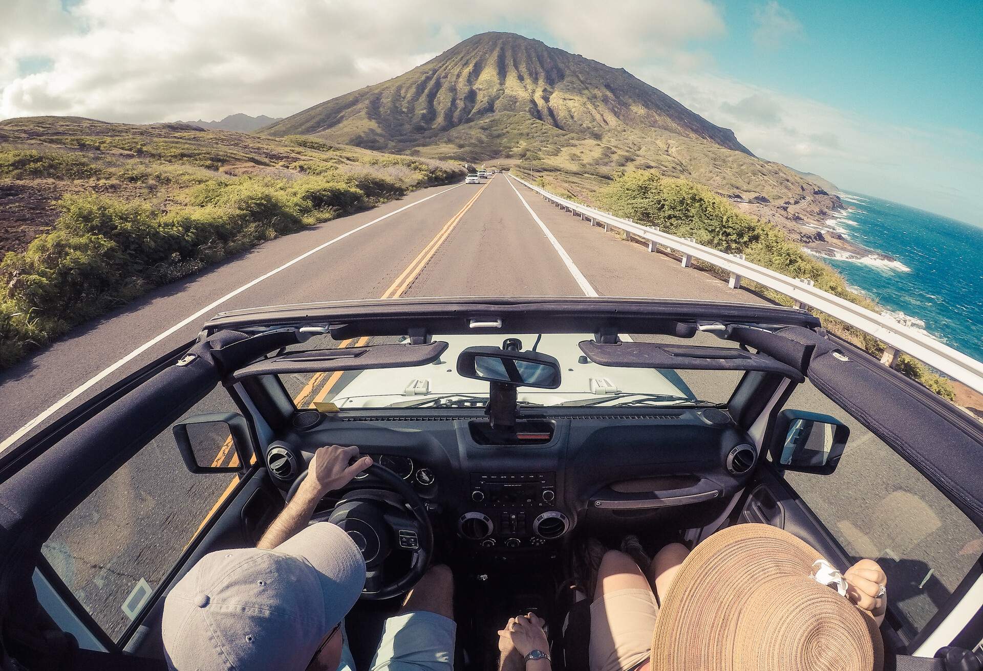 View of a car being driven on a coastal road