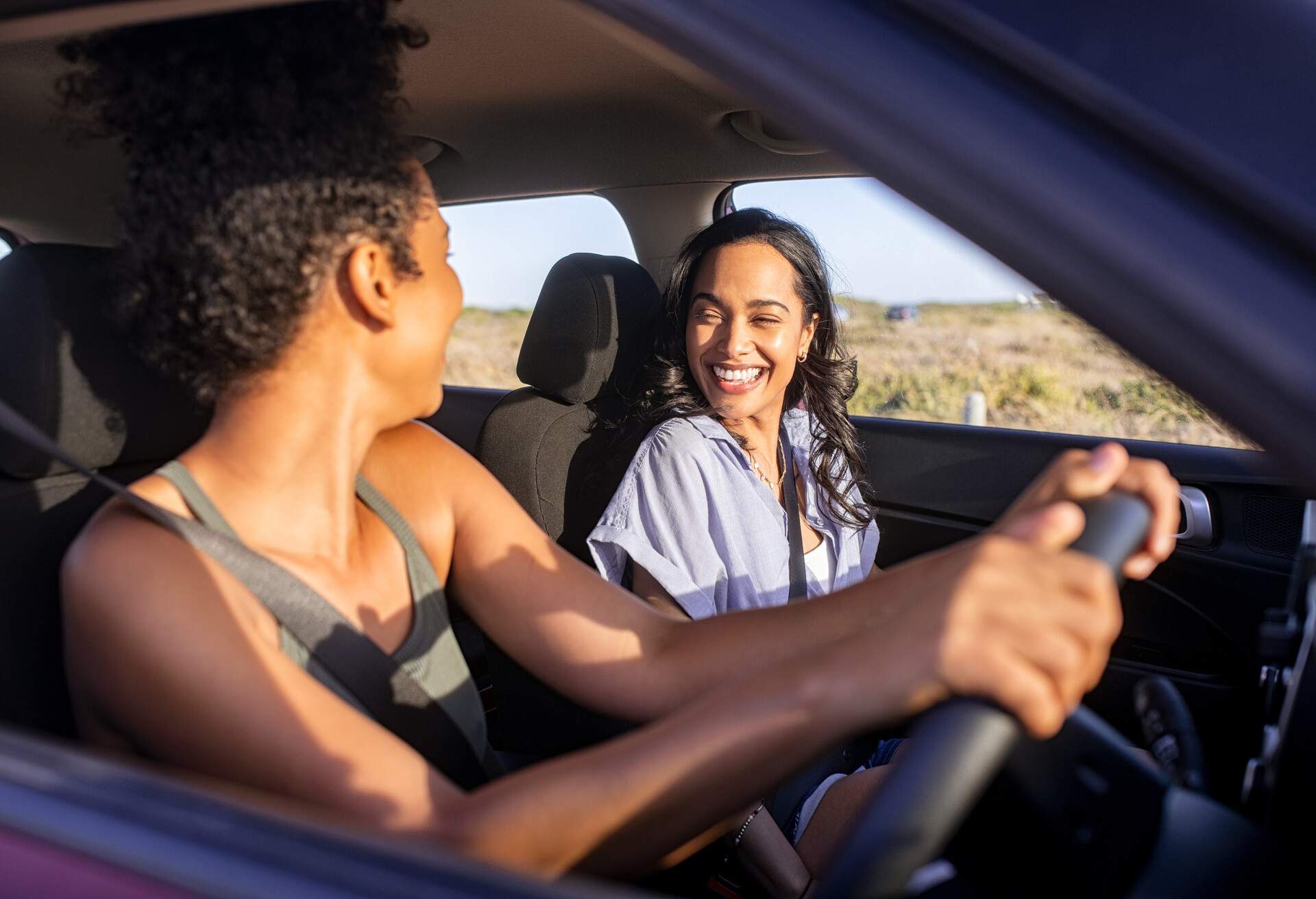 Two smiling women in a car