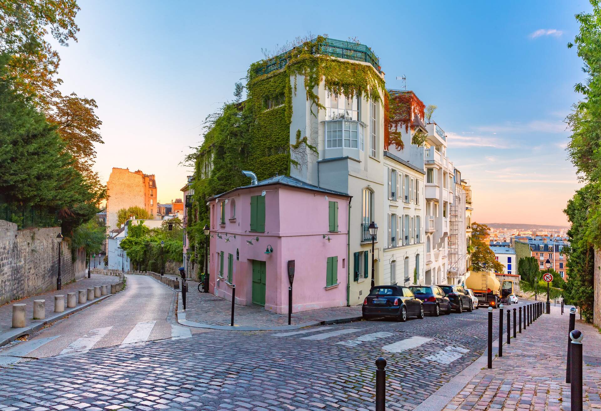 Old street with pink house at sunrise, Montmartre in Paris, France