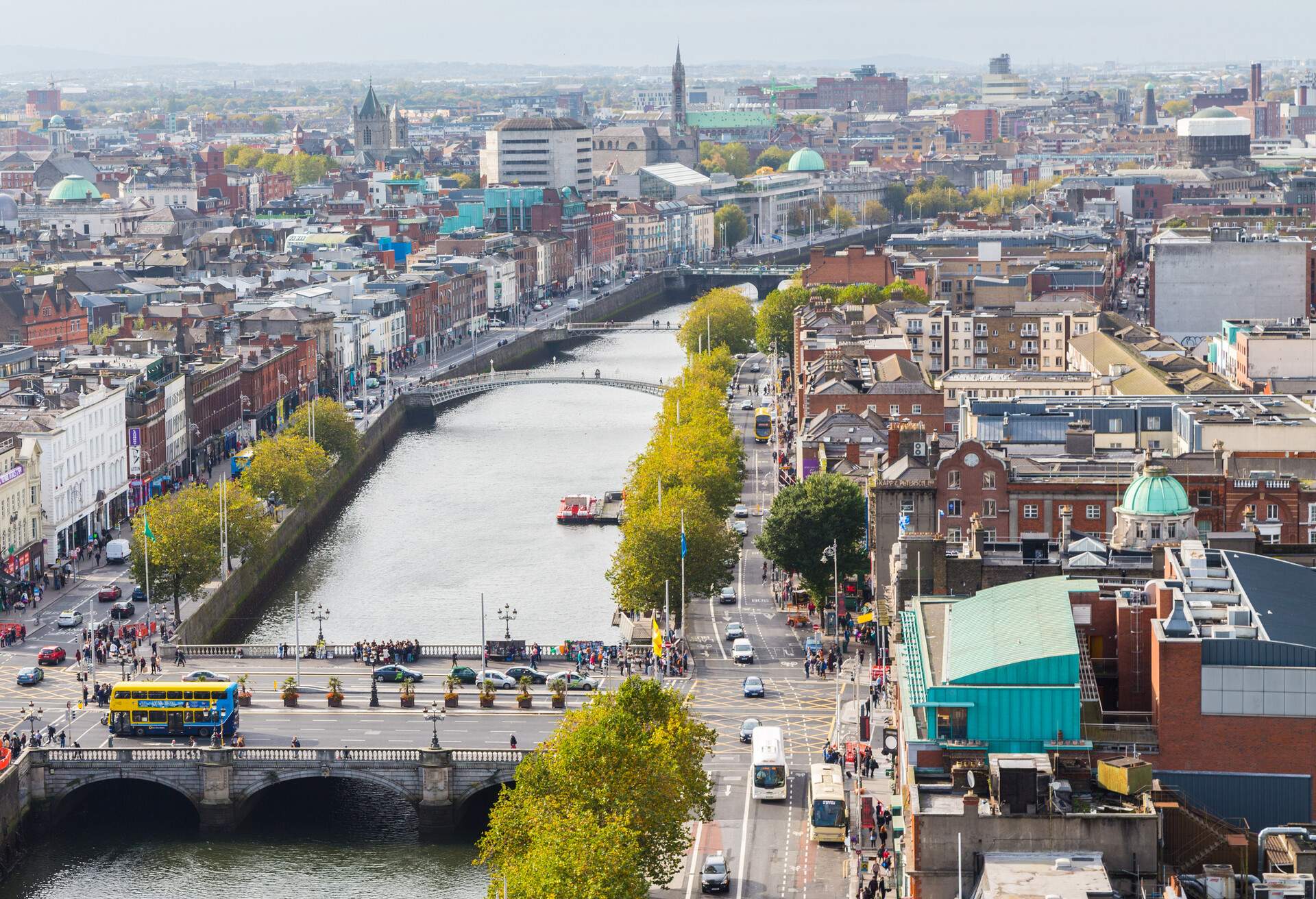 Numerous bridges cross a river that separates the town from its tree-lined streets. 