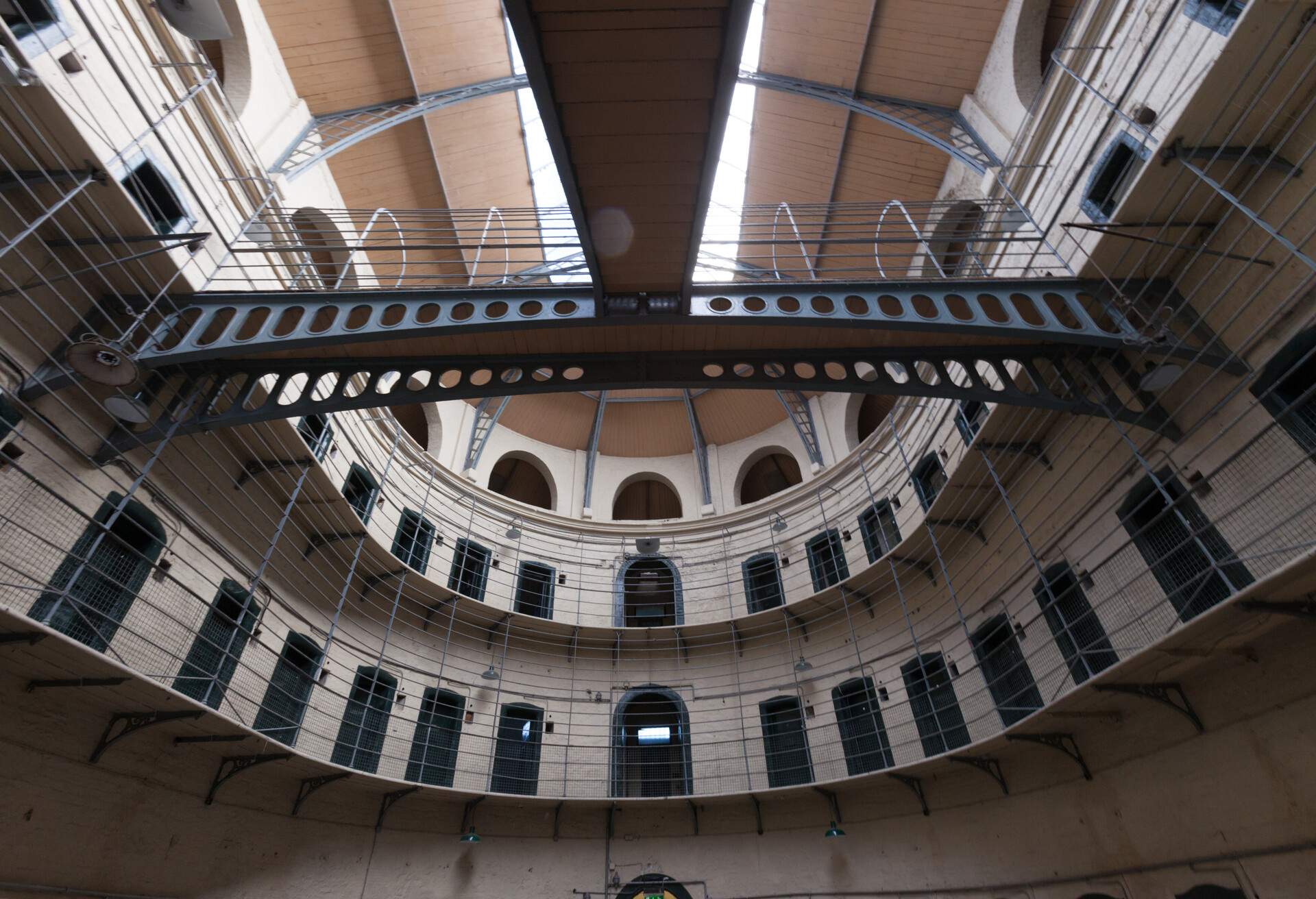 A multi-storey building with gated balconies and multiple doors.