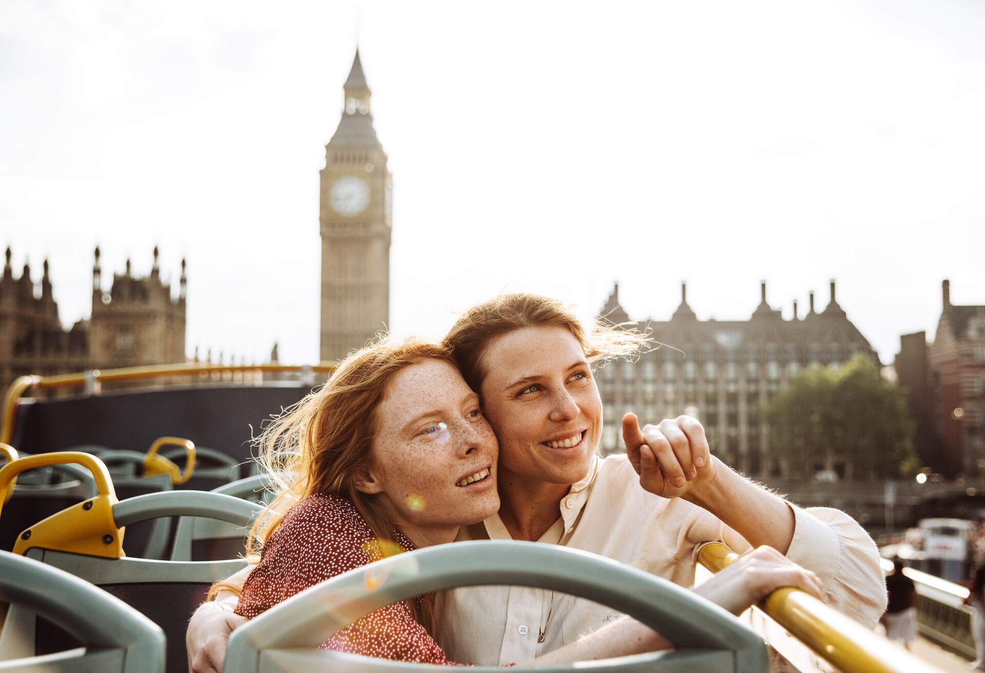 LGBTQ couple on open top bus in London, England, United Kingdom