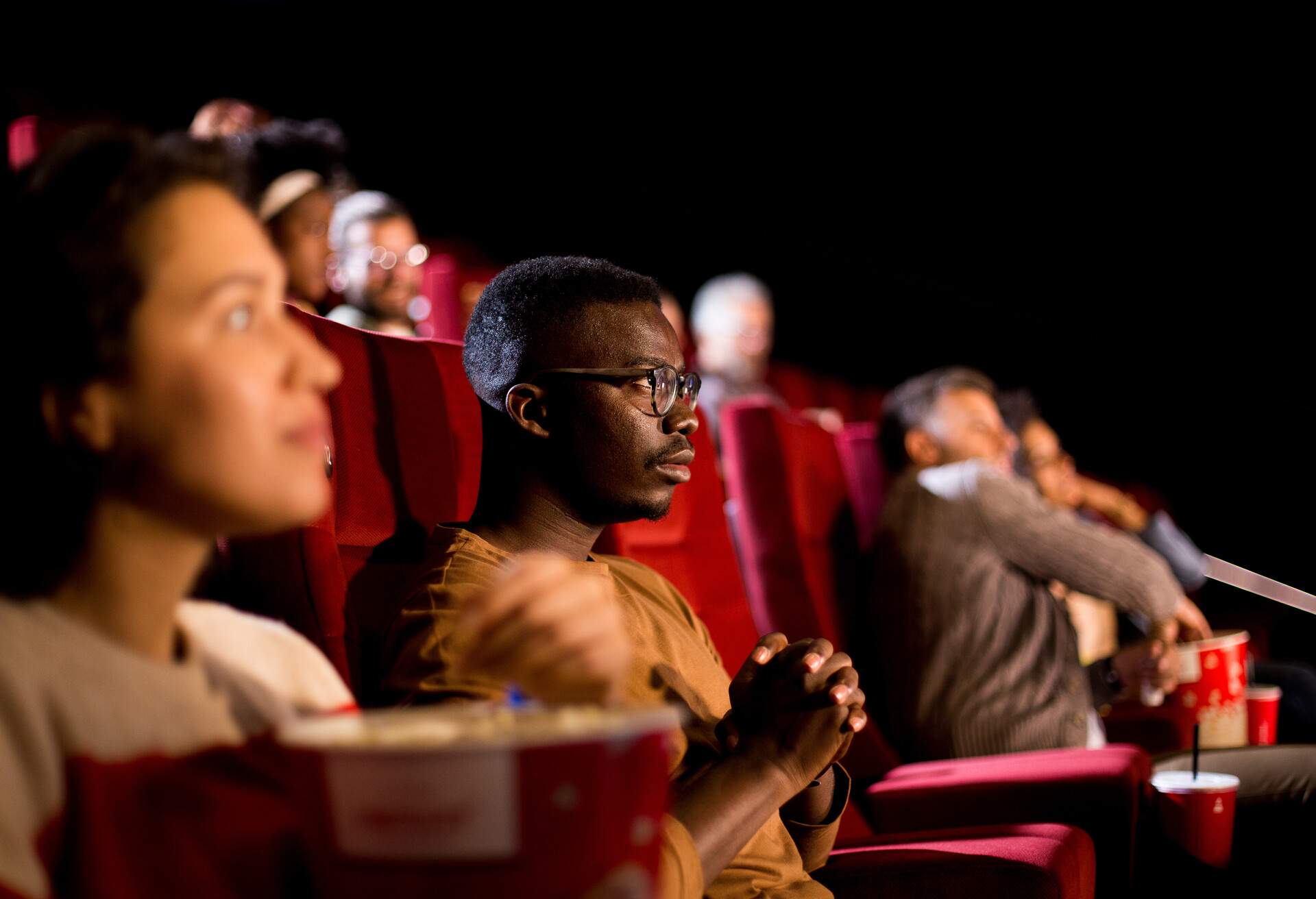 African-American man watching a movie at the cinema