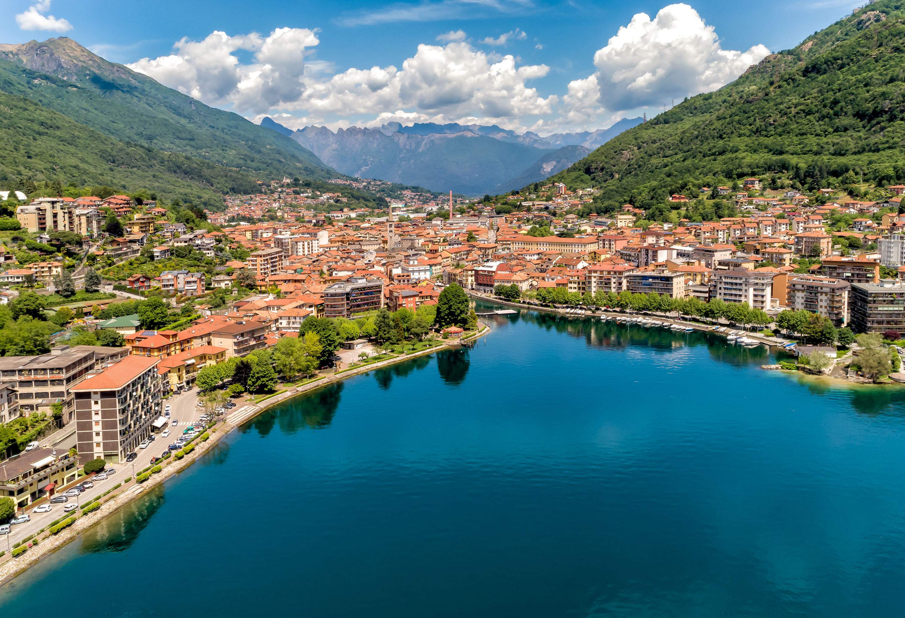 A lakeside town's urban landscape between the forested valleys.