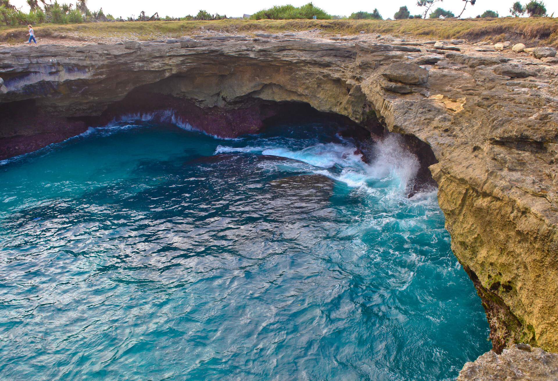 Devil's tears is a tidal pool with rough waves crashing into cliffside rocks.