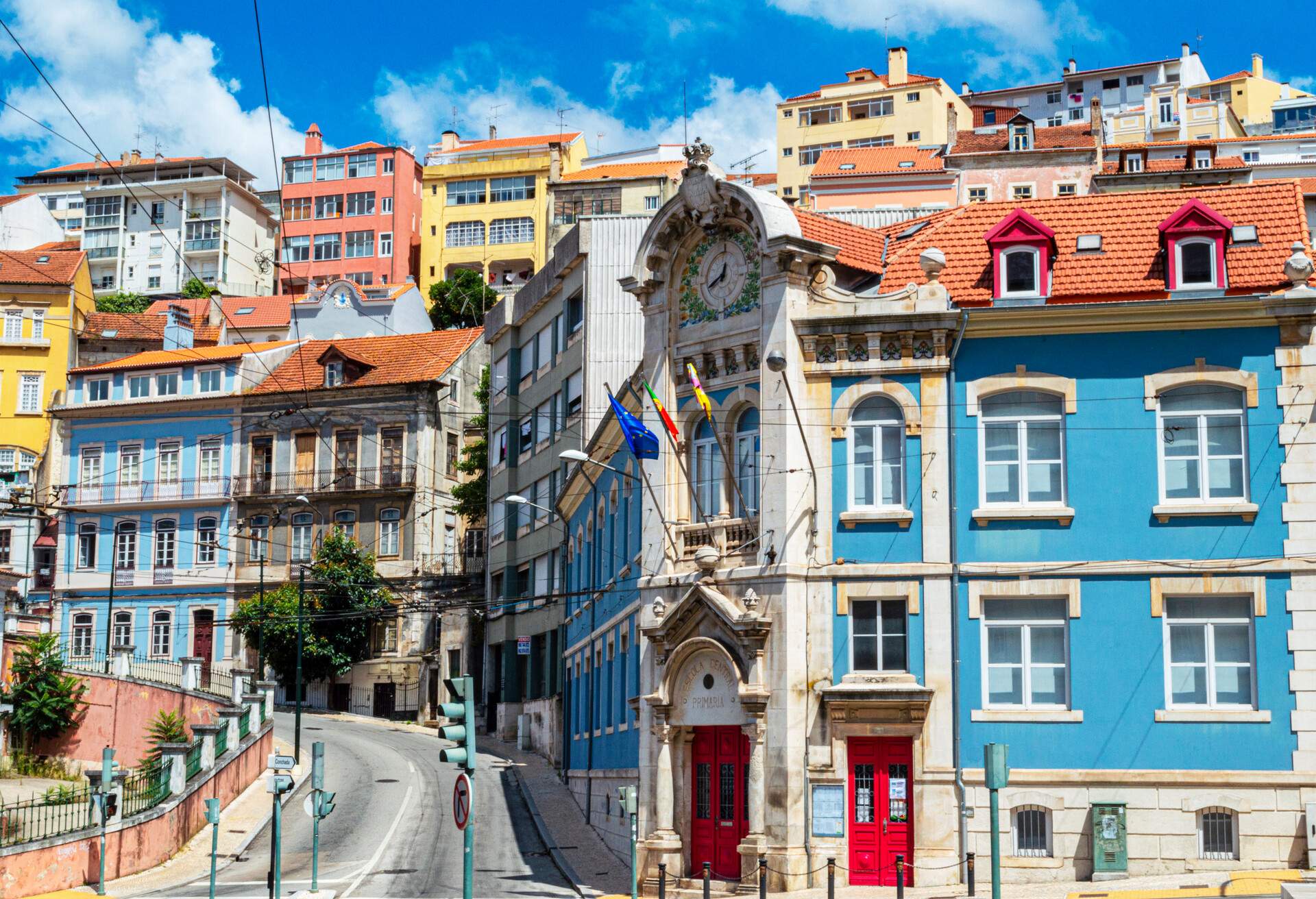 Historic architecture with colourful facades along a steep roadway.