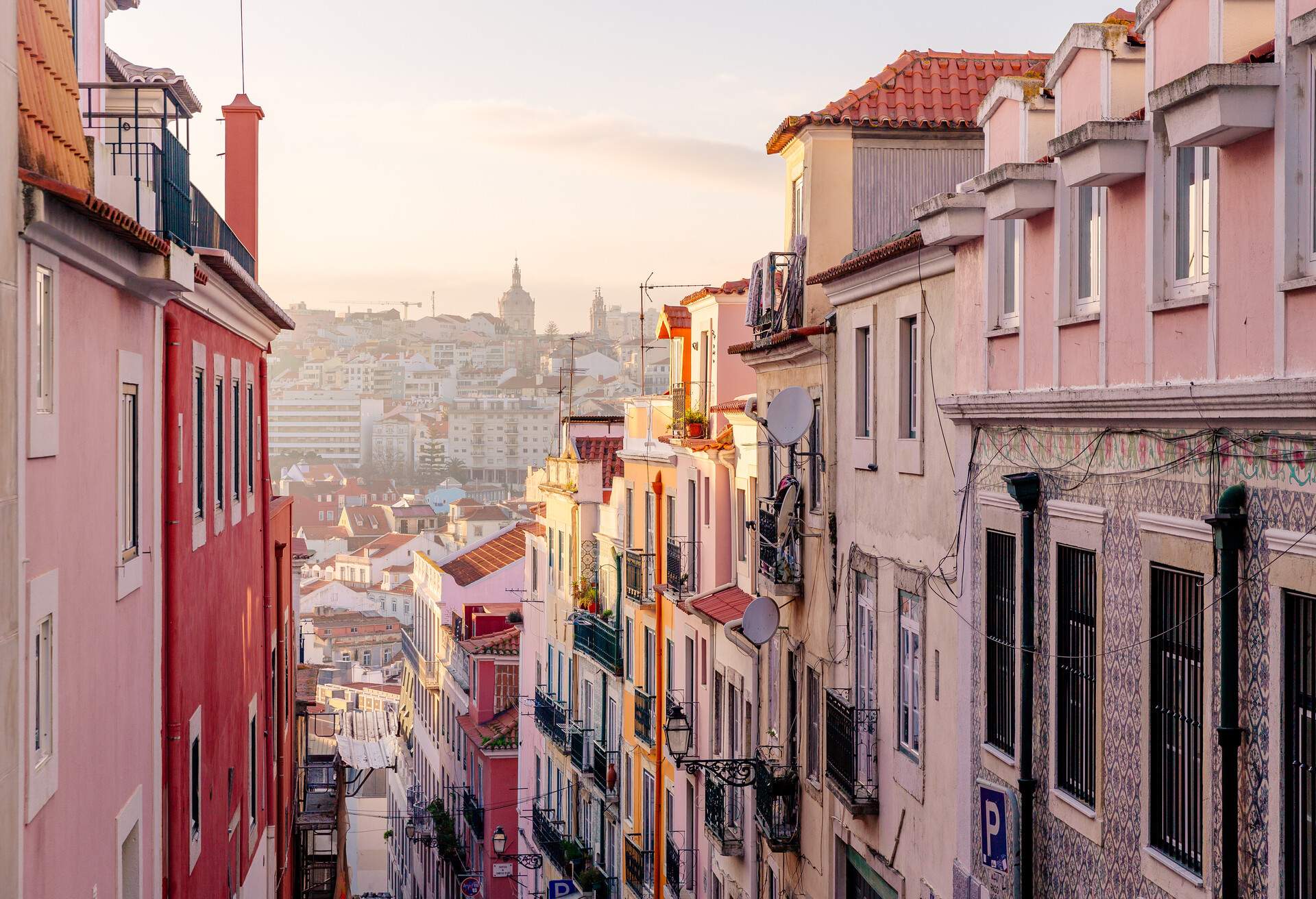 Tall and colourful buildings along a narrow street.