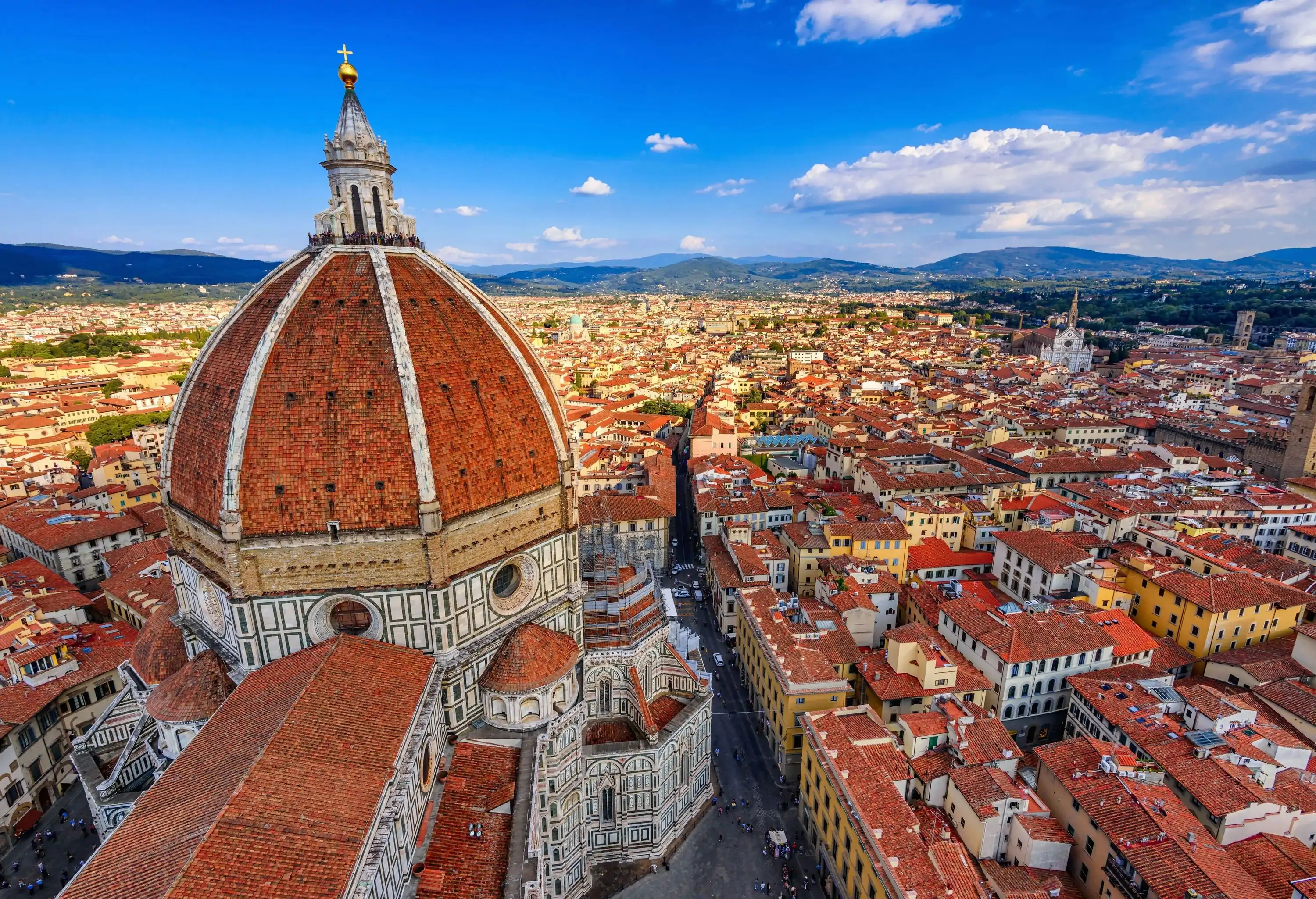 A stunning architectural masterpiece with a striking red-tiled dome that dominates the city skyline and adds to the picturesque charm of the town.