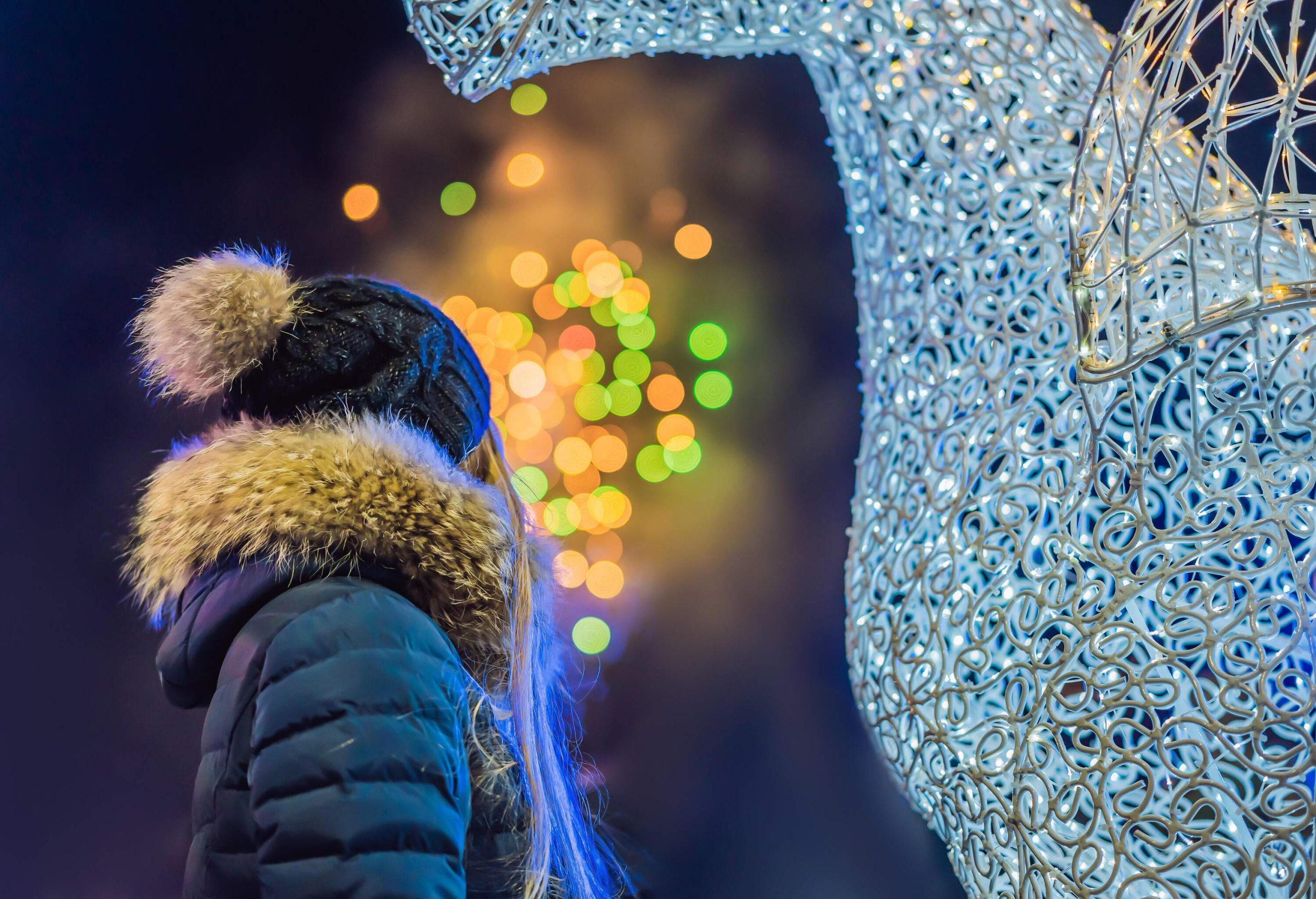 Young woman celebrating christmas and watching christmas fireworks. Crazy 2020 is over, it's 2021.