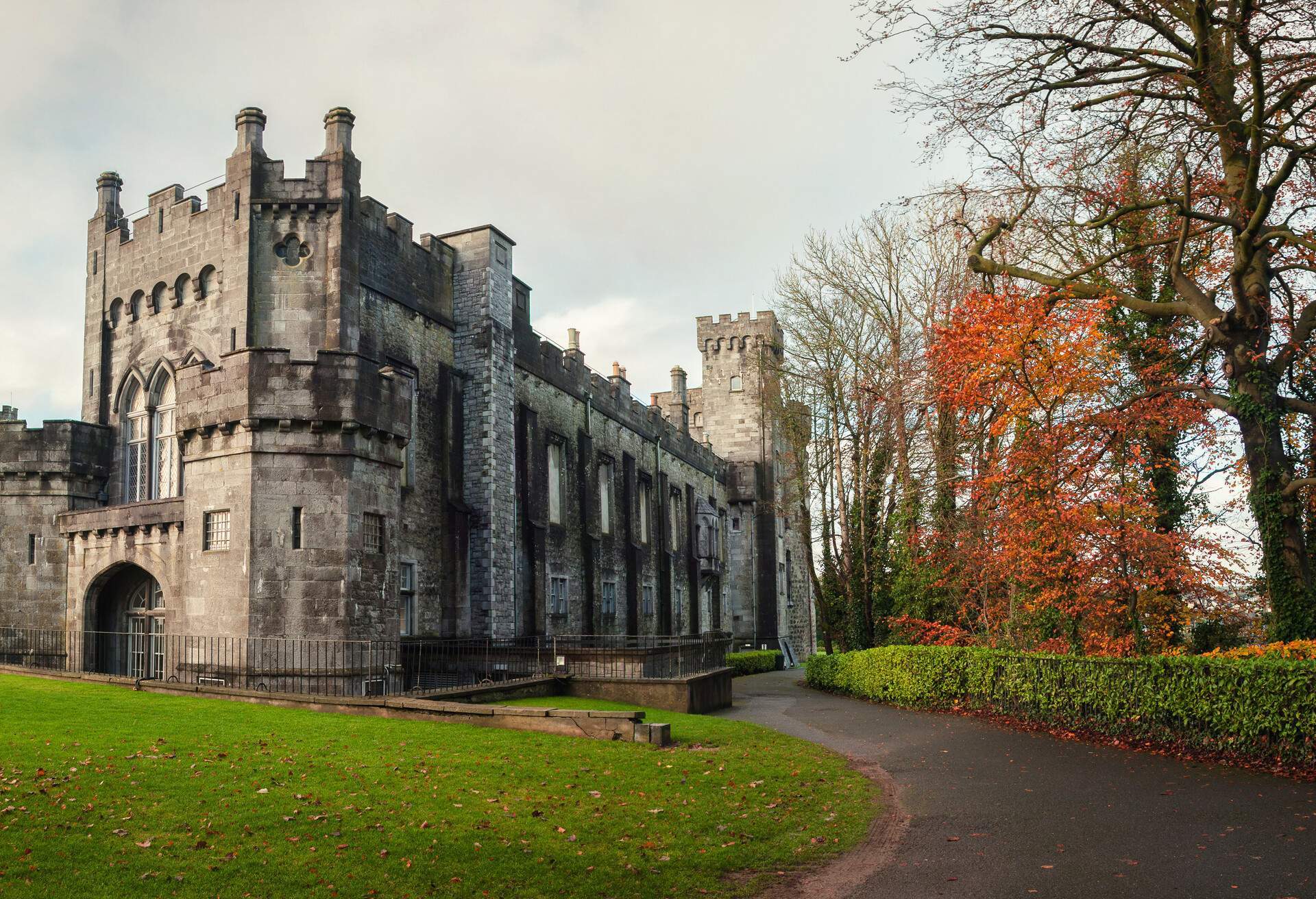 Kilkenny Castle and gardens in autumn with heavy clouds. It is one of the most visited tourist sites in Ireland.