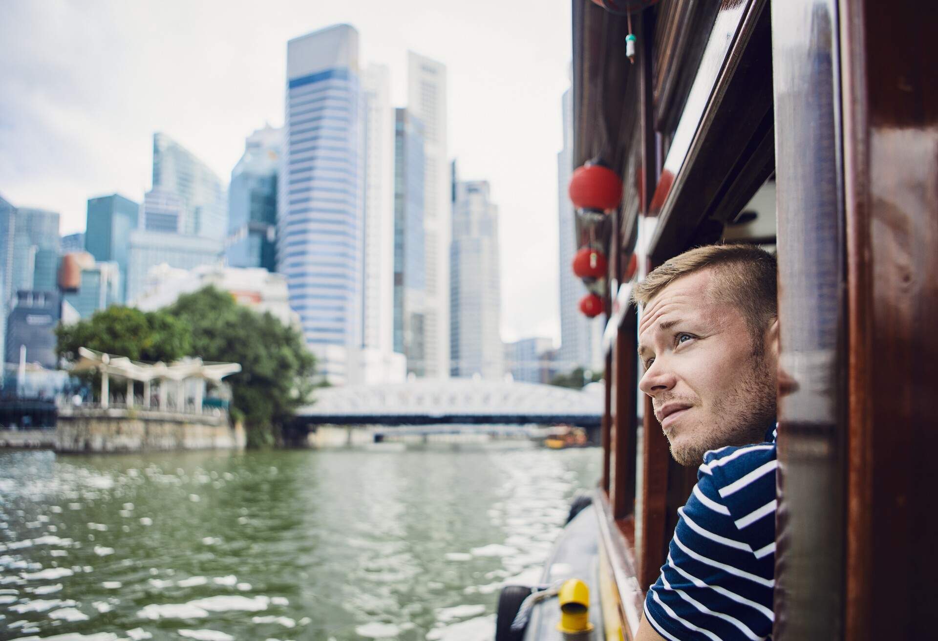 Man looking out ferry window in Singapore