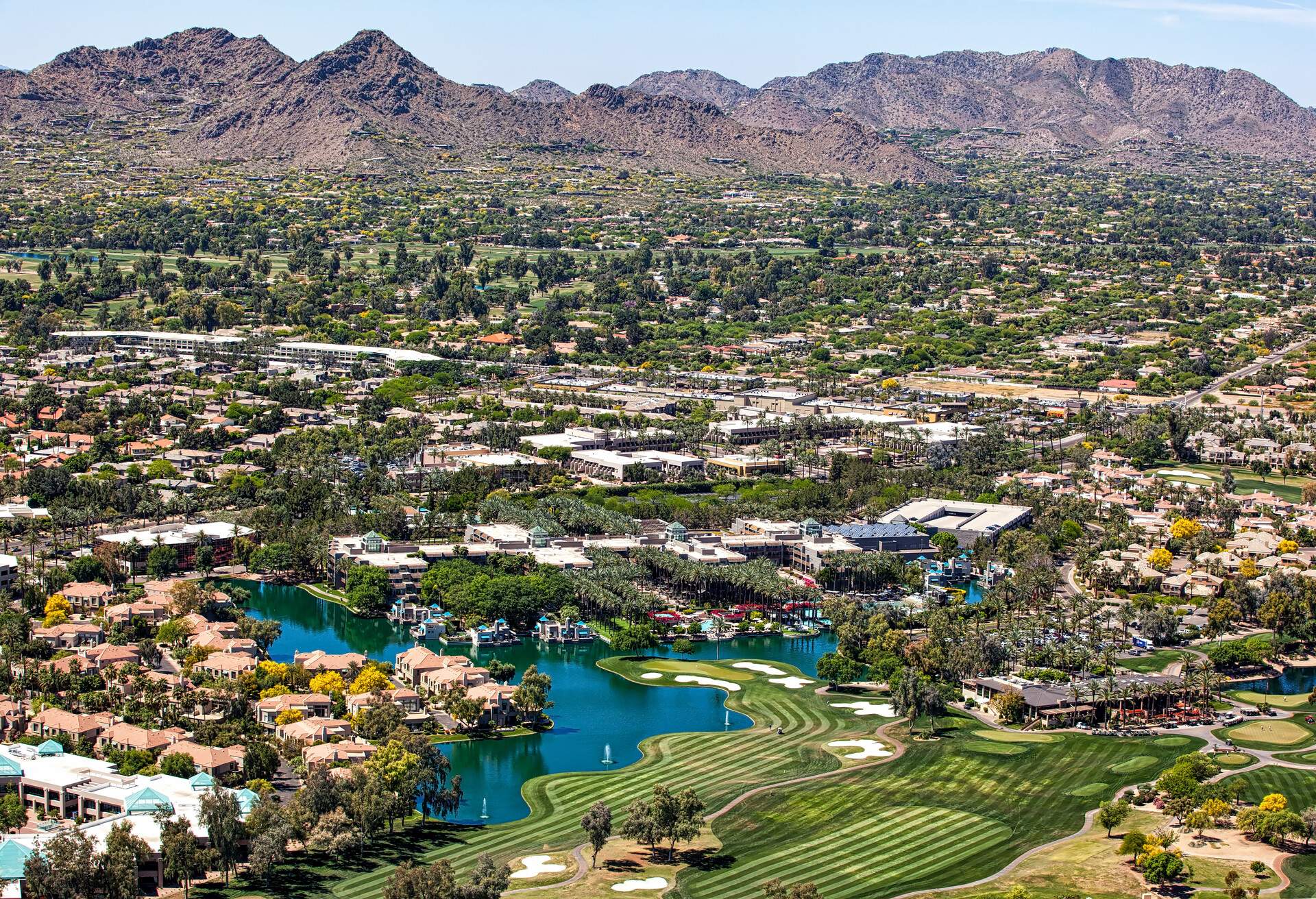 Over Scottsdale, Arizona looking to the southwest at golf courses, resorts, luxury homes and Mummy Mountain