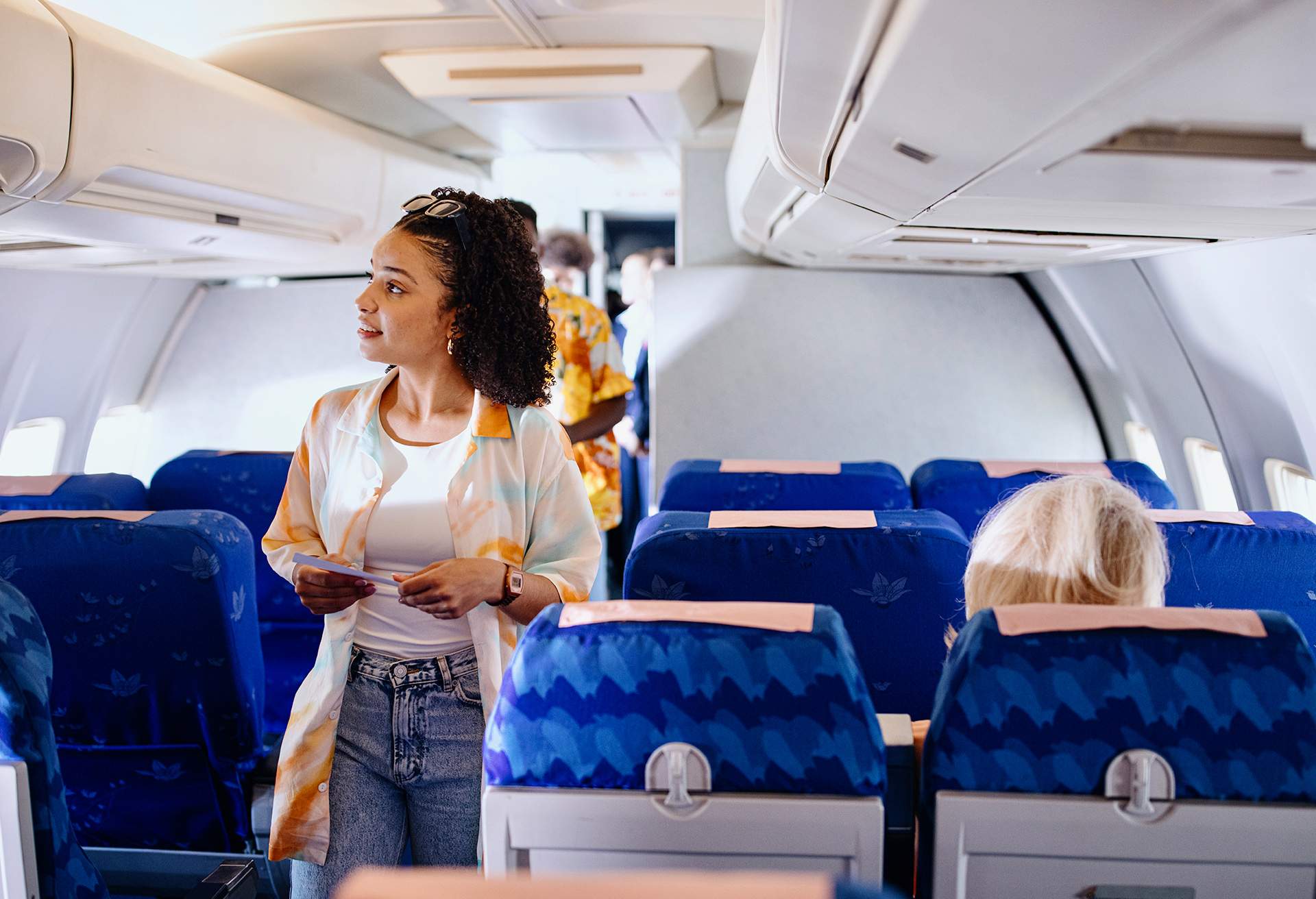 Passengers boarding plane and searching for their sets