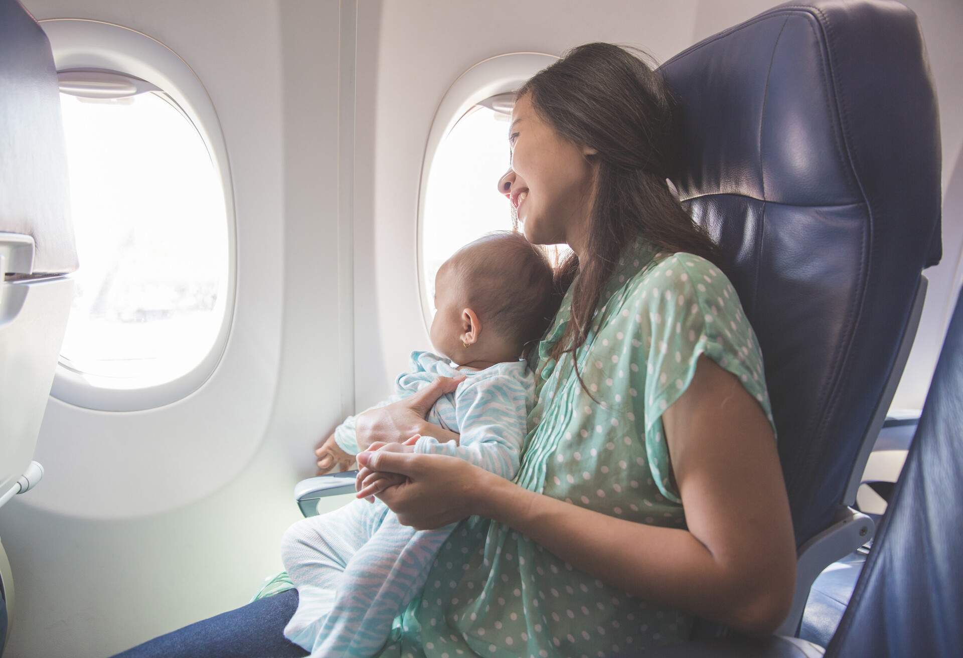 Mother travelling with infant on plane