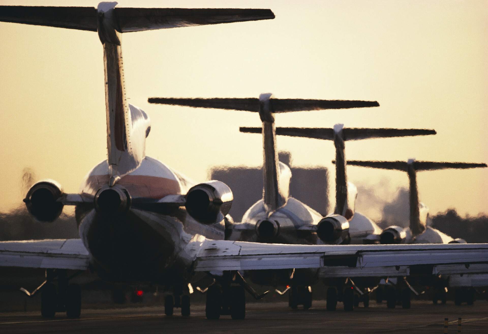Airplanes lined up on runway ready to take off.