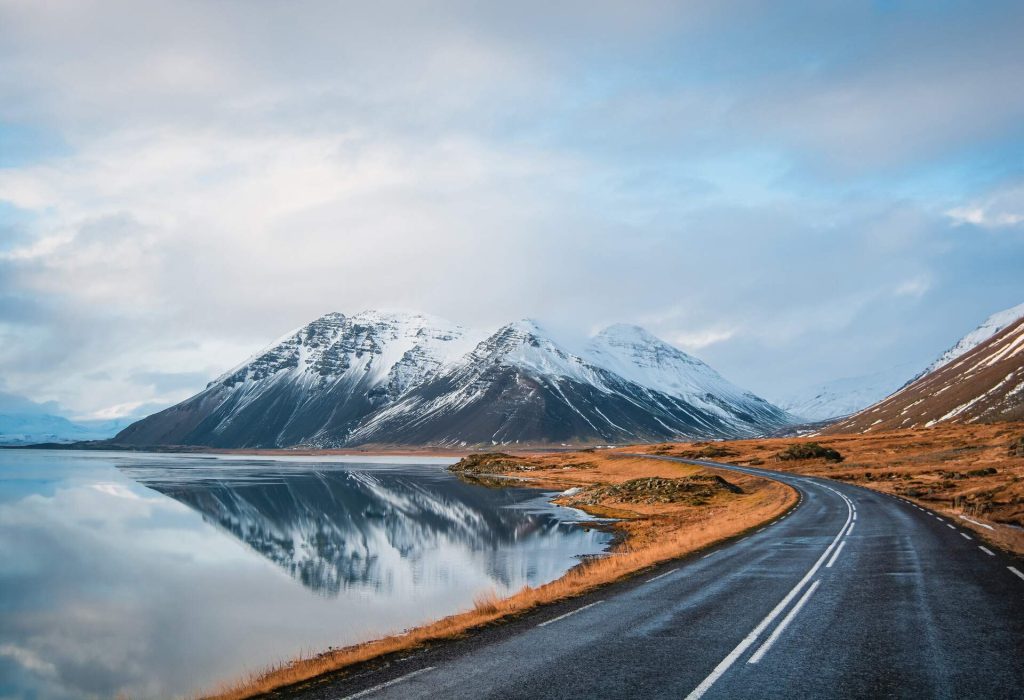 Empty road in Iceland with mountains in the background