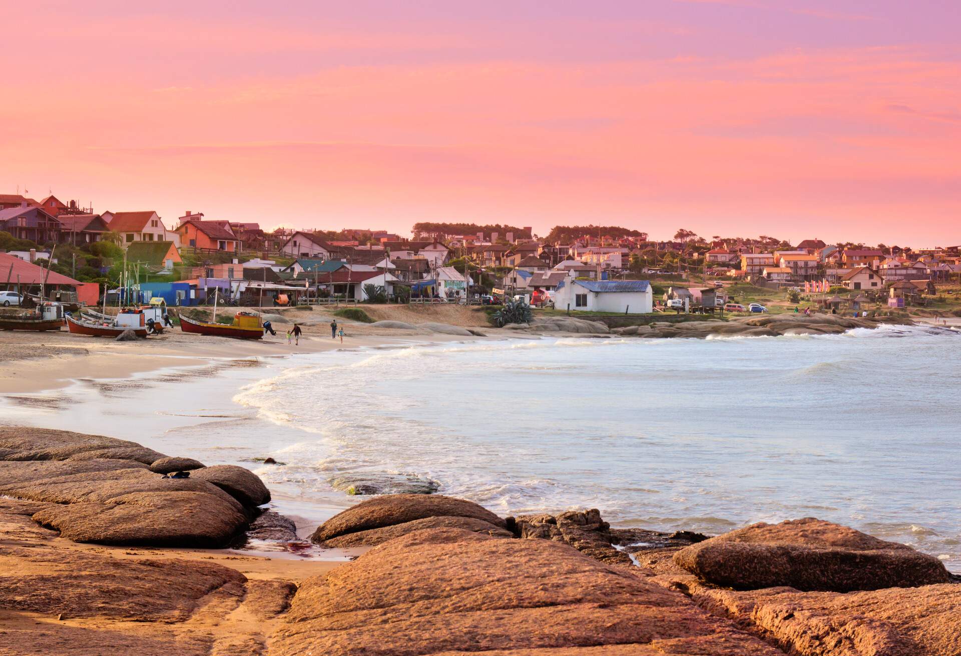 A coastal fishing village with old and colourful houses overlooking the tranquil sea under the scenic twilight sky.