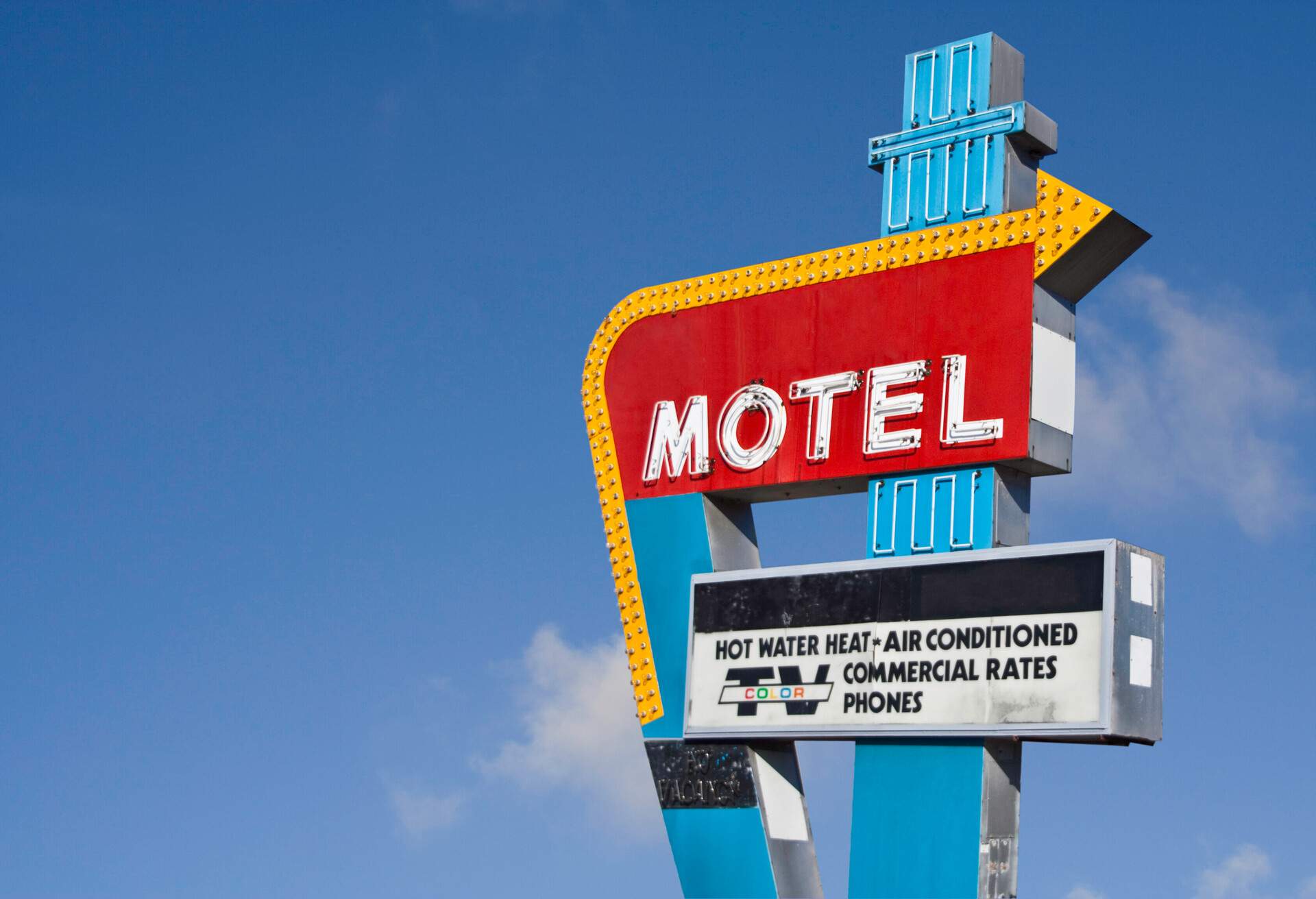Retro motel sign with a blue sky in the background