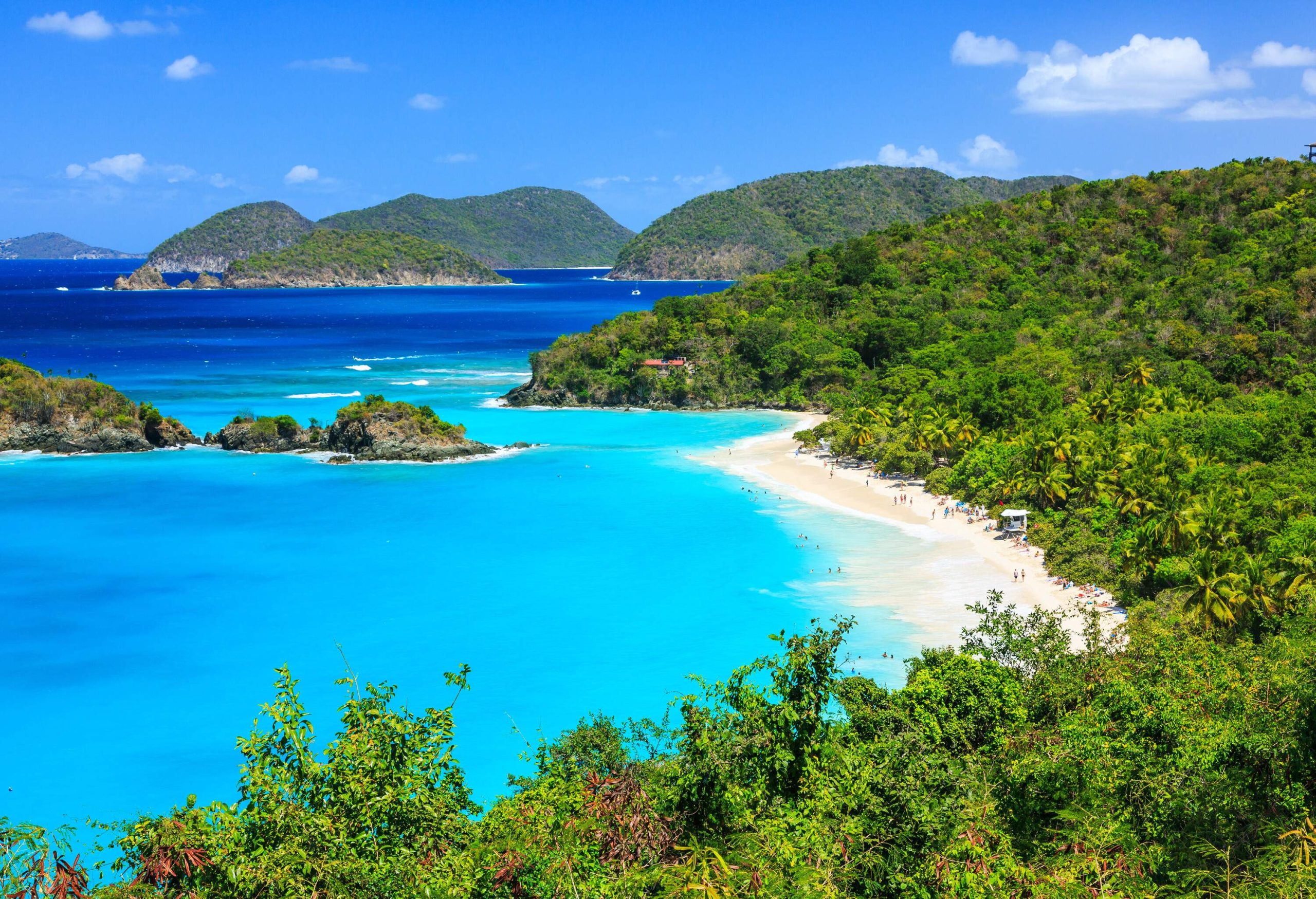 Turquoise water and a beach with islands in the background