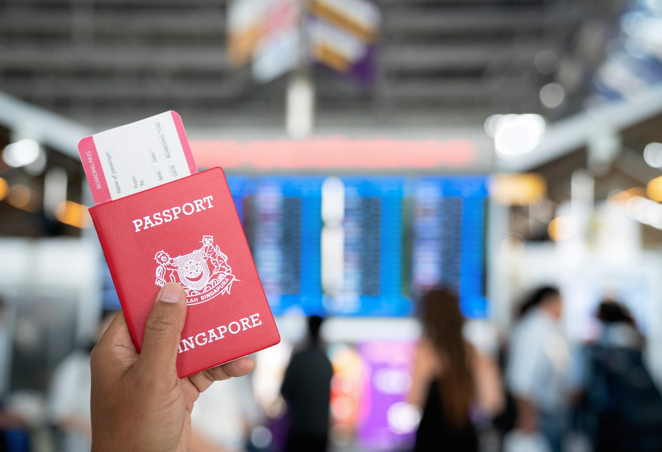 Hand holding passports and boarding pass in the international airport.