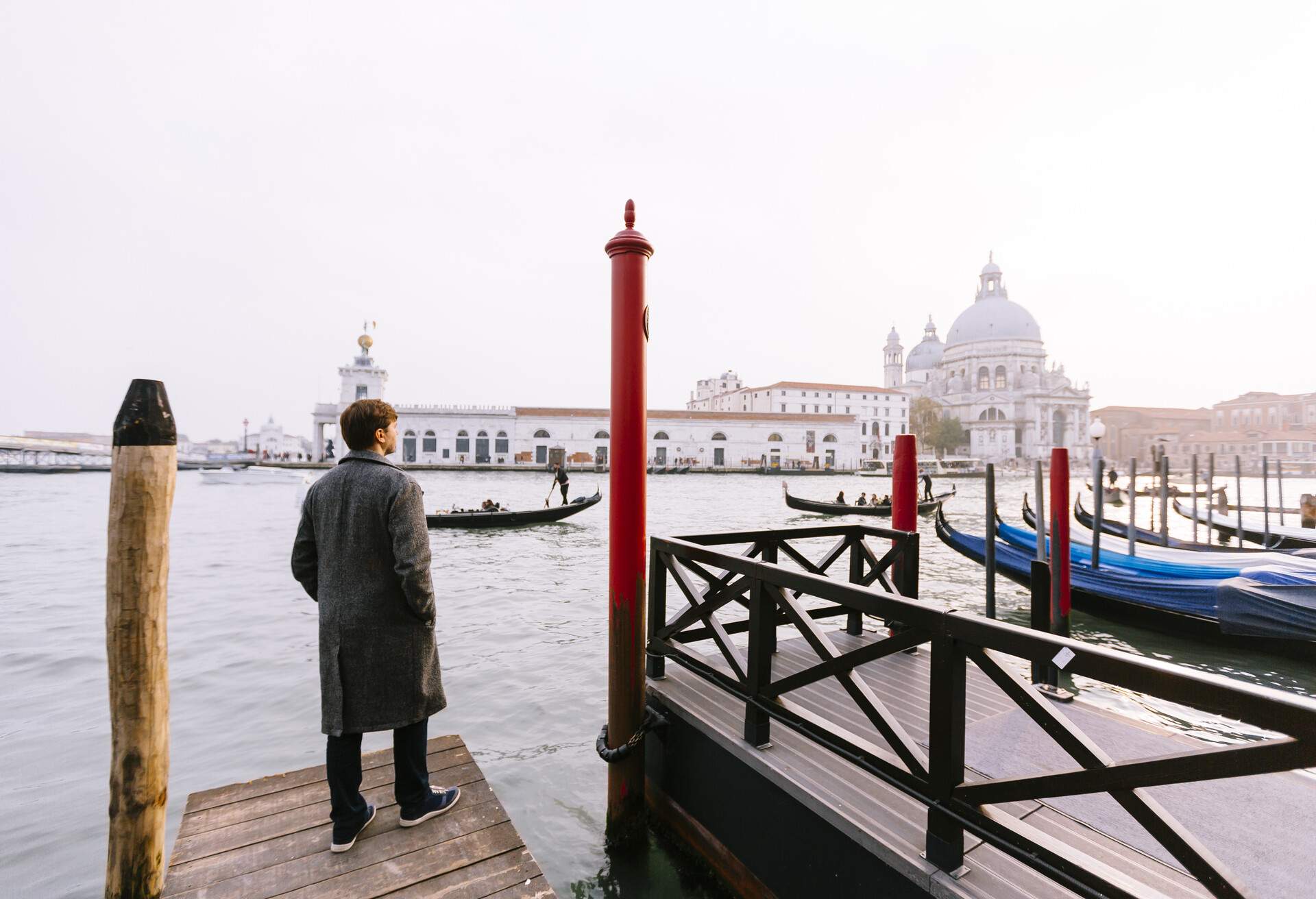 Man overlooking the Venice lagoon on a grey winter day