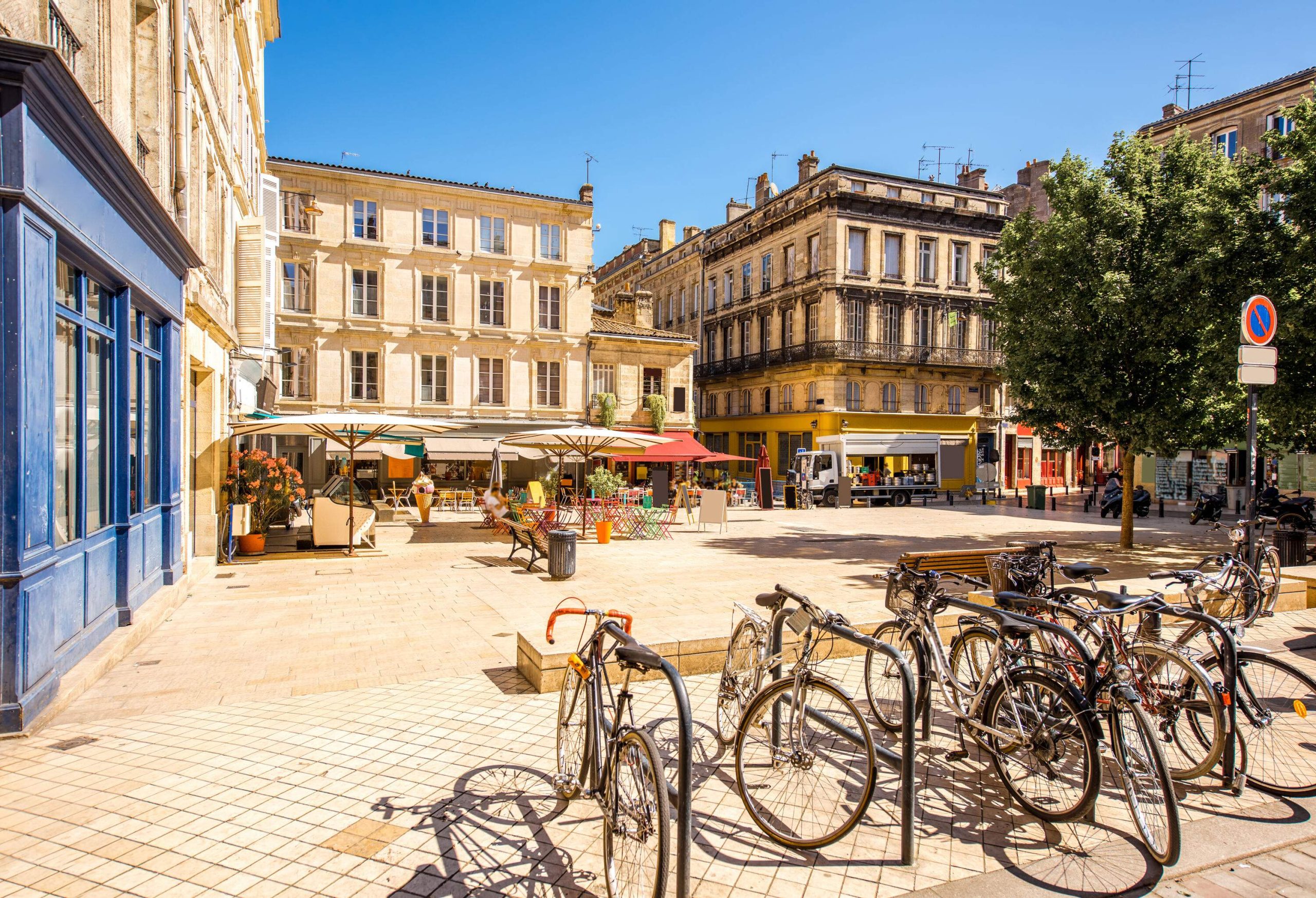 A small plaza with public bike racks and outdoor cafes.